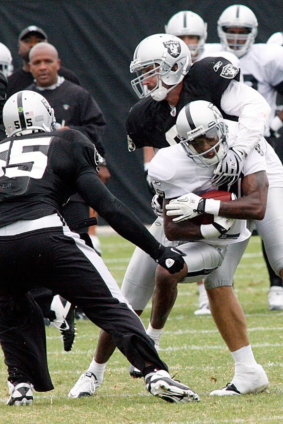 Trevor Scott makes a tackle in camp. The Raiders didn't have too much of that from his position last year.