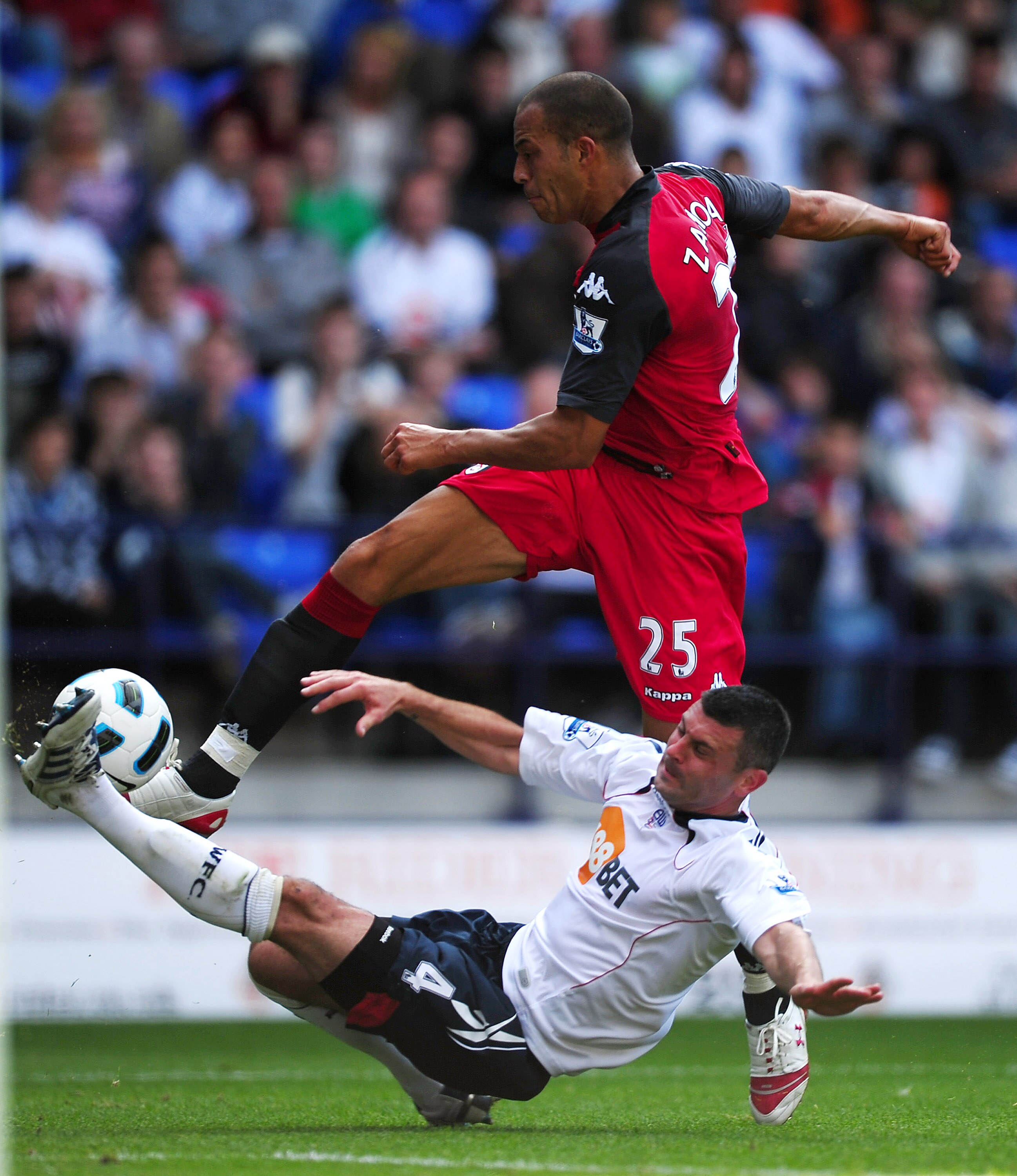 BOLTON, ENGLAND - AUGUST 14: Bobby Zamora (top) of Fulham has his shot blocked by Paul Robinson of Bolton during the Barclays Premier League match between Bolton Wanderers and Fulham at Reebok Stadium on August 14, 2010 in Bolton, England.  (Photo by Laur