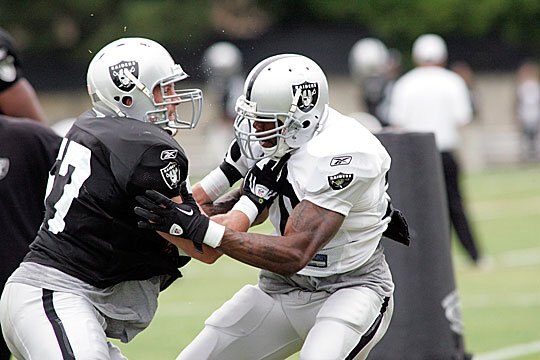 Ricky Brown gets physical with Darren McFadden.
