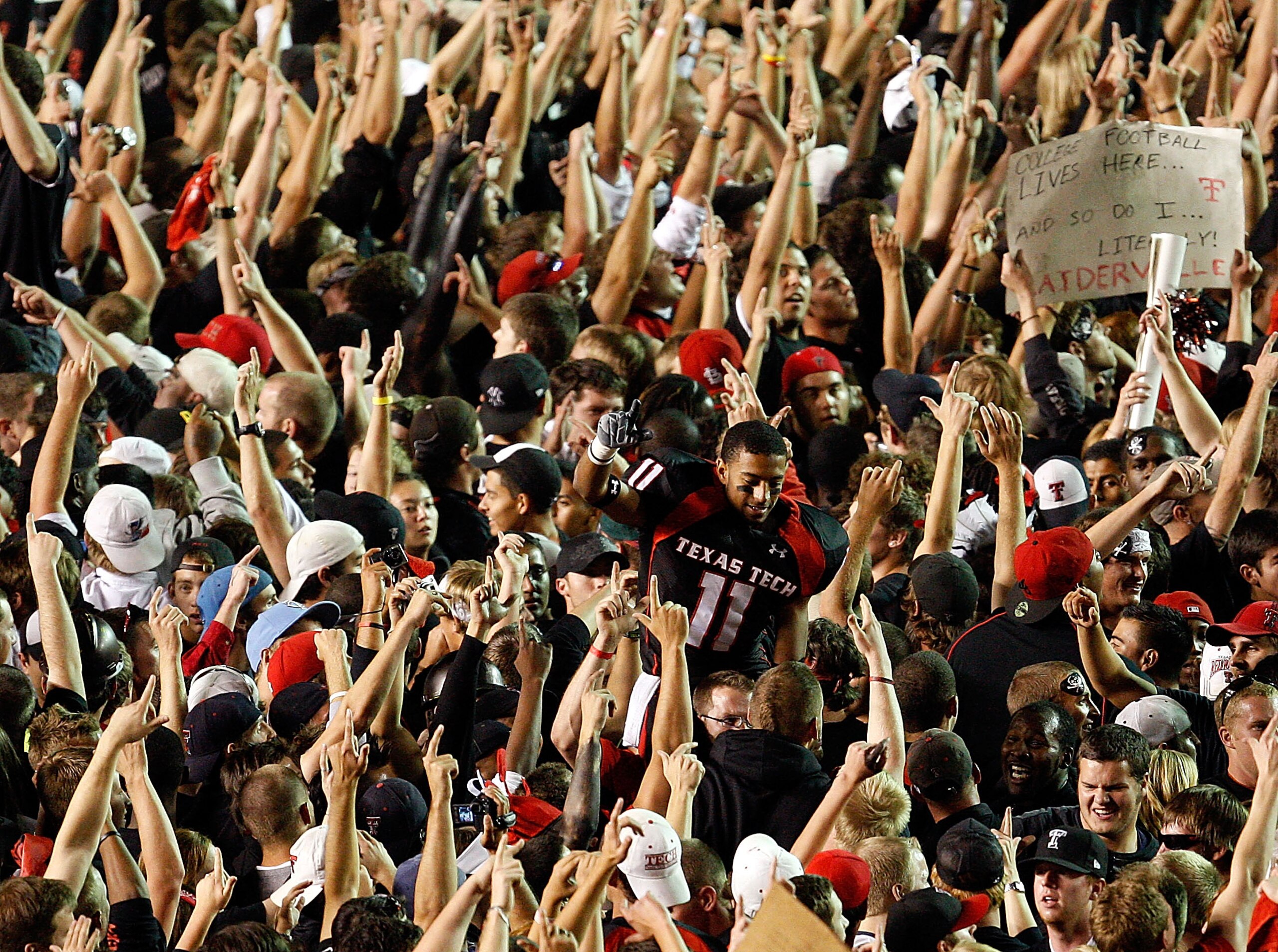 LUBBOCK, TX - NOVEMBER 01:  Fans swarm the field and lift Tramain Swindall #11 after the Texas Tech Red Raiders defeated the Texas Longhorns with a final score of 34-33 on November 1, 2008 at Jones Stadium in Lubbock, Texas.  (Photo by Jamie Squire/Getty 