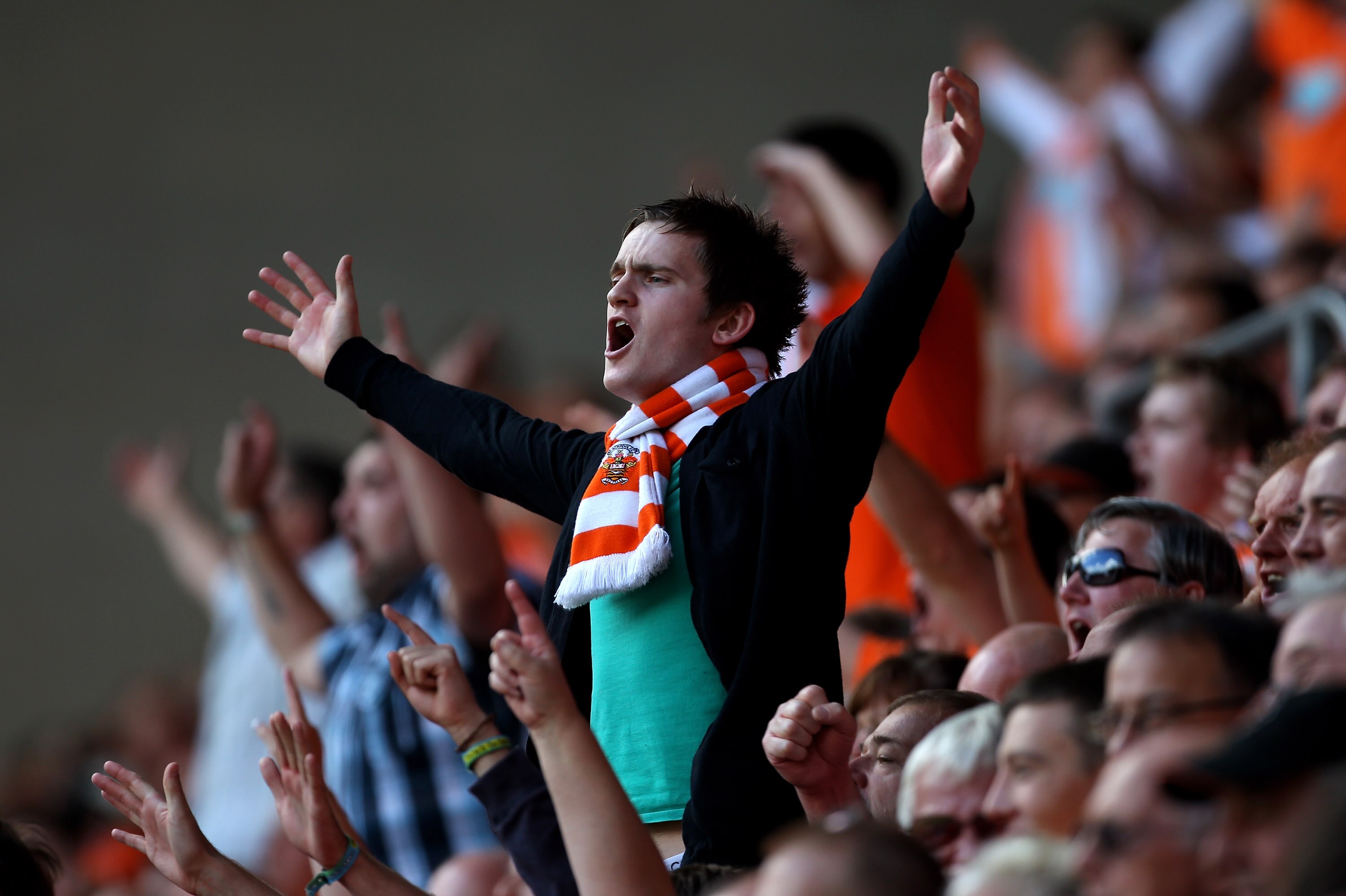 WIGAN, ENGLAND - AUGUST 14:  Blackpool fans show their support during the Barclays Premier League match between Wigan Athletic and Blackpool at the DW Stadium on August 14, 2010 in Wigan, England.  (Photo by Alex Livesey/Getty Images)