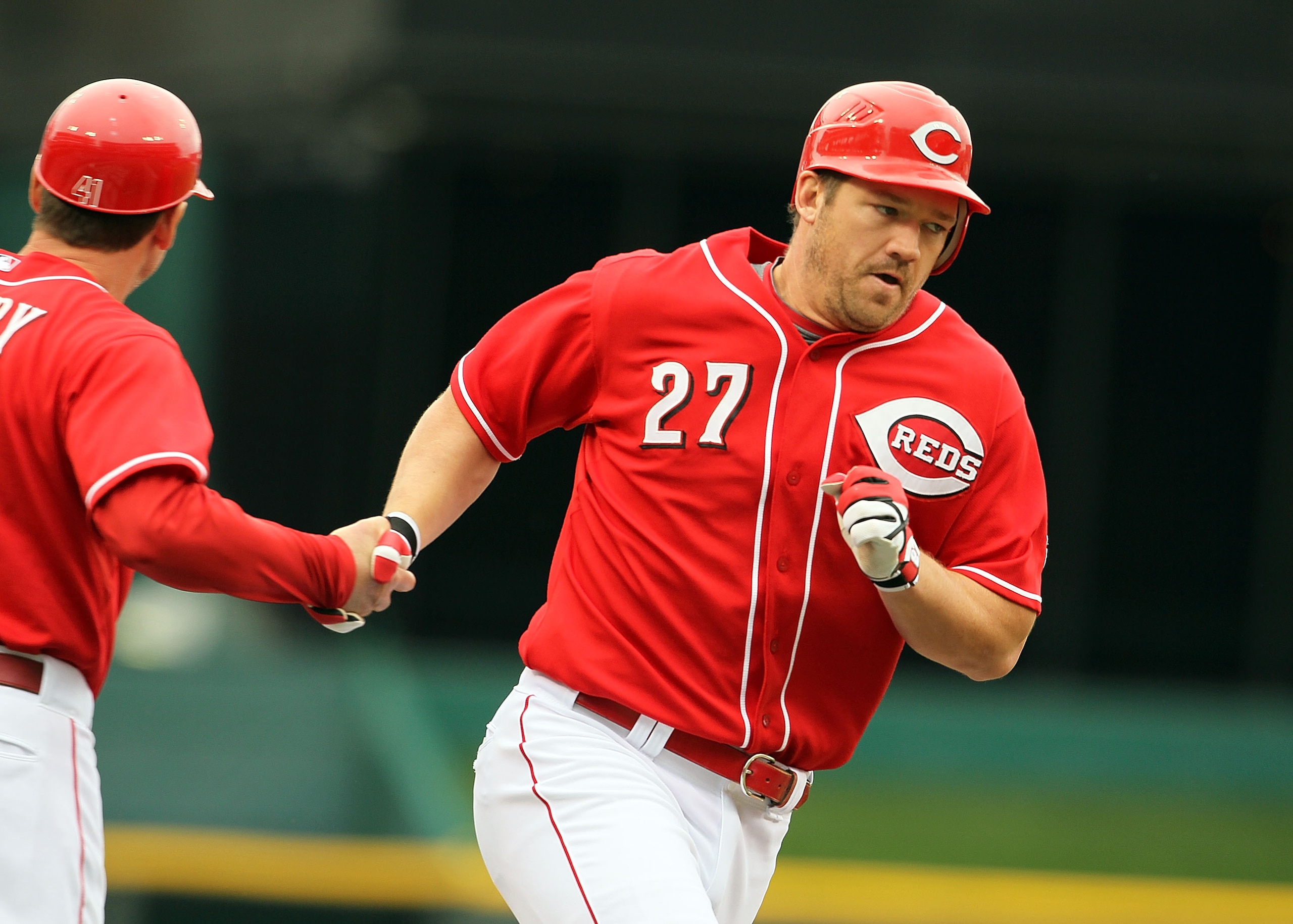 CINCINNATI - MAY 16:  Scott Rolen #4 of the Cincinnati Reds is congratulated by third base coach Mark Berry after hitting a home run during the game against the St. Louis Cardinals at Great American Ball Park on May 16, 2010 in Cincinnati, Ohio.  (Photo b