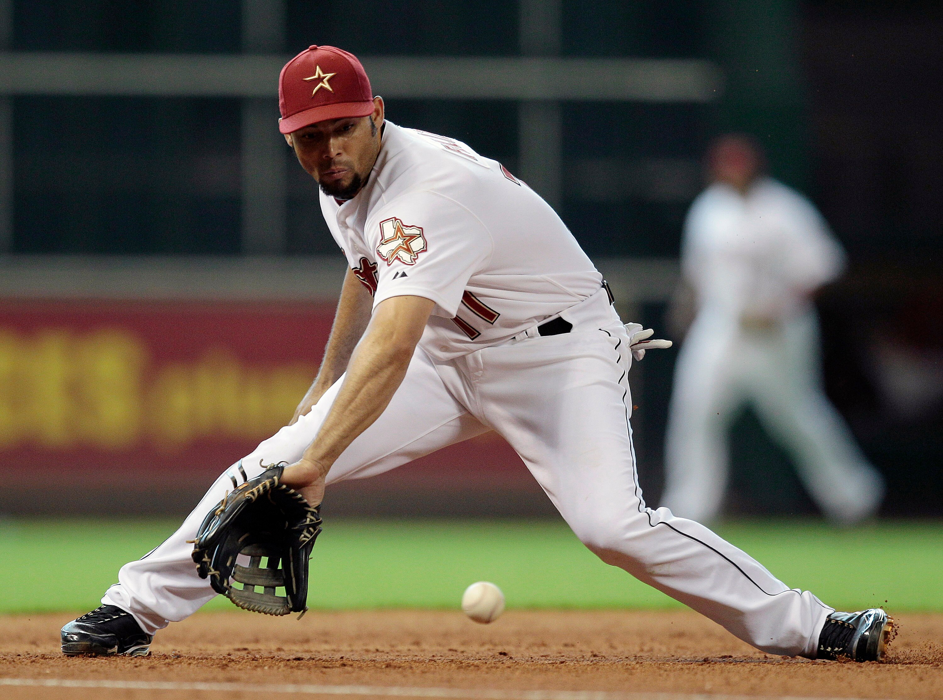 HOUSTON - JUNE 24:  Third baseman Pedro Feliz #77 of the Houston Astros makes a backhand play against the San Francisco Giants at Minute Maid Park on June 24, 2010 in Houston, Texas.  (Photo by Bob Levey/Getty Images)