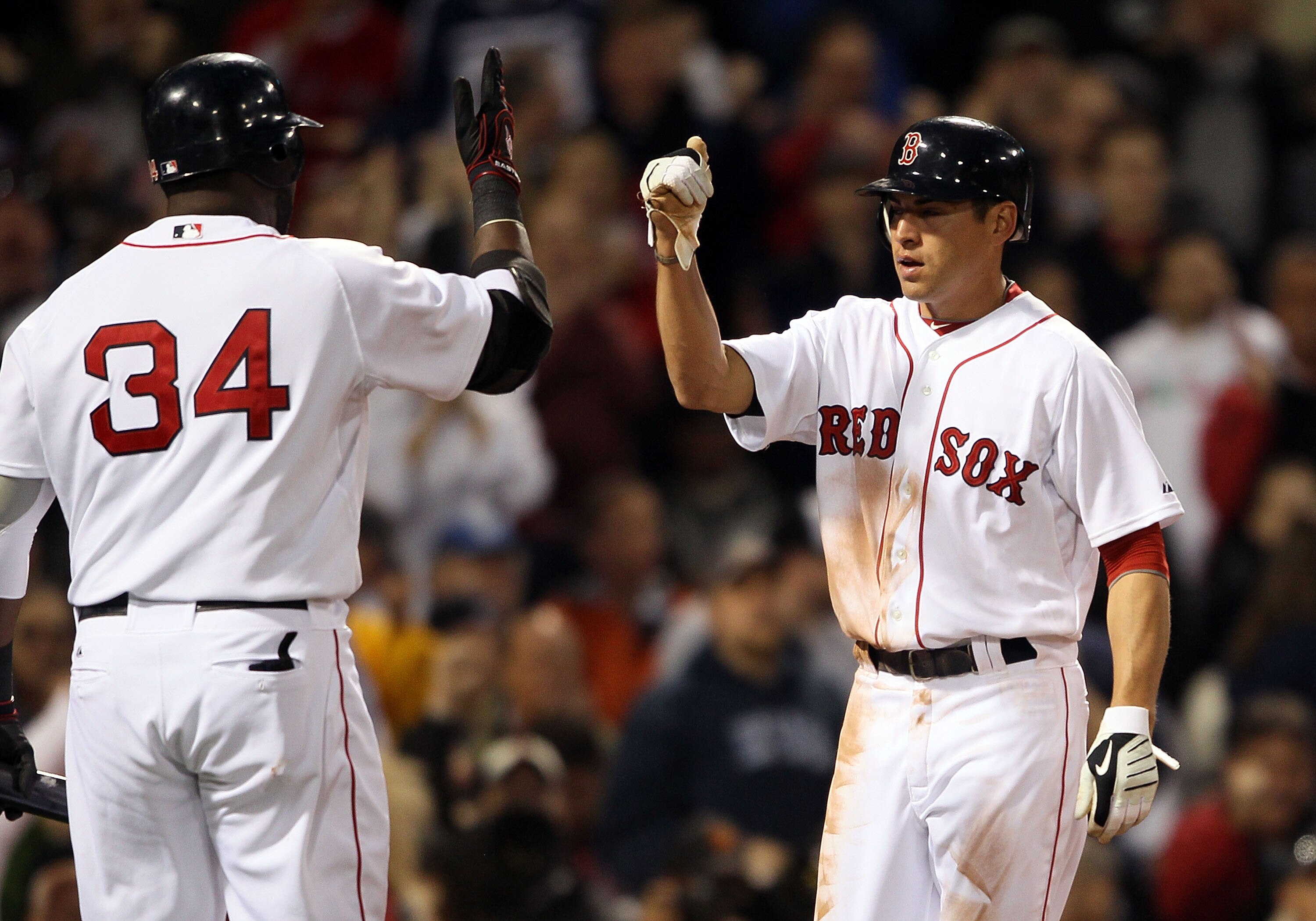 BOSTON - APRIL 06:  Jacoby Ellsbury #2 of the Boston Red Sox celebrate his run with teammate David Ortiz #34 in the first inning against the New York Yankees on April 6, 2010 at Fenway Park in Boston, Massachusetts.  (Photo by Elsa/Getty Images)