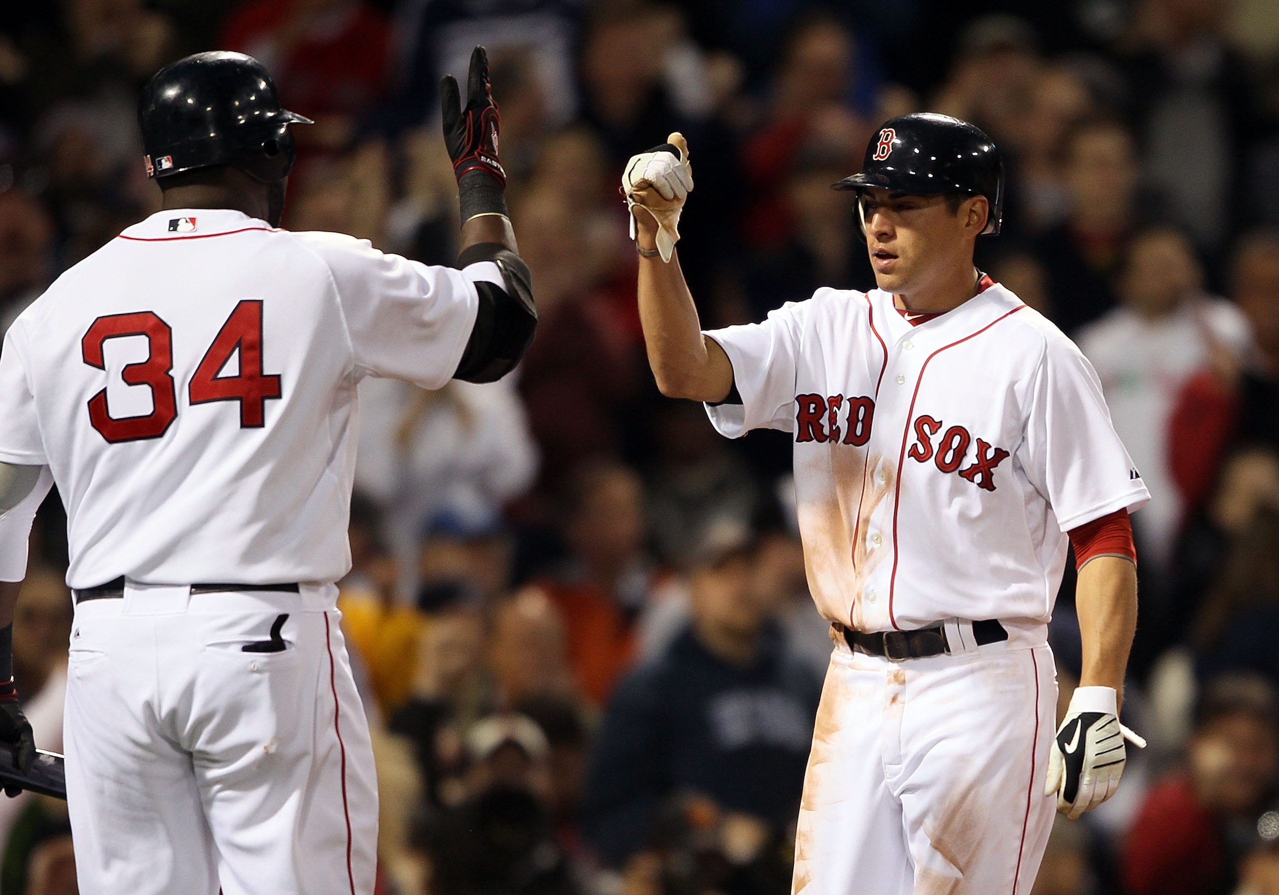 BOSTON - APRIL 06:  Jacoby Ellsbury #2 of the Boston Red Sox celebrate his run with teammate David Ortiz #34 in the first inning against the New York Yankees on April 6, 2010 at Fenway Park in Boston, Massachusetts.  (Photo by Elsa/Getty Images)