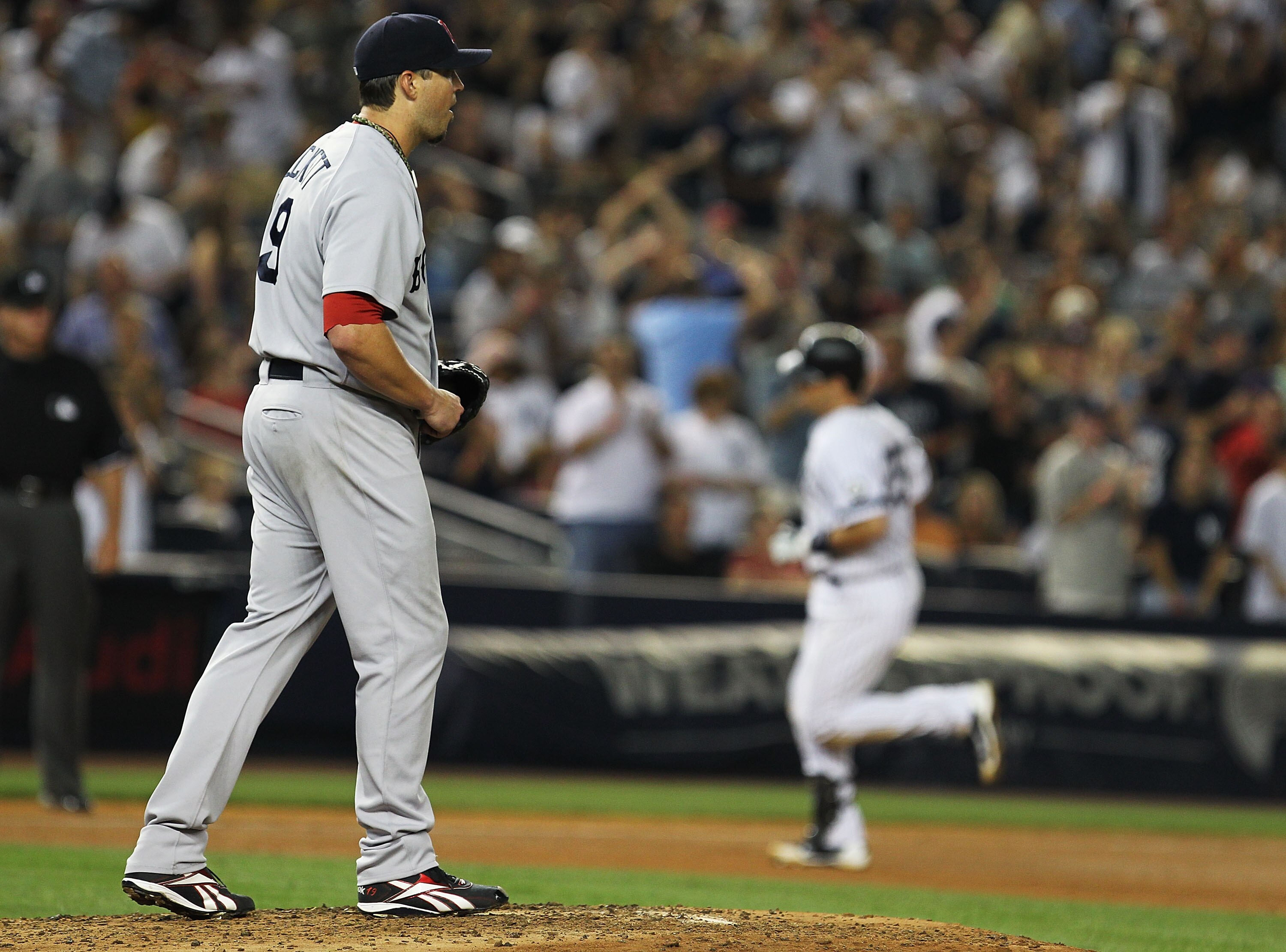 NEW YORK - AUGUST 08:  Mark Teixeira #25 of the New York Yankees rounds the bases after hitting a home run against Josh Beckett #19 the Boston Red Sox during their game on August 8, 2010 at Yankee Stadium in the Bronx borough of New York City.  (Photo by