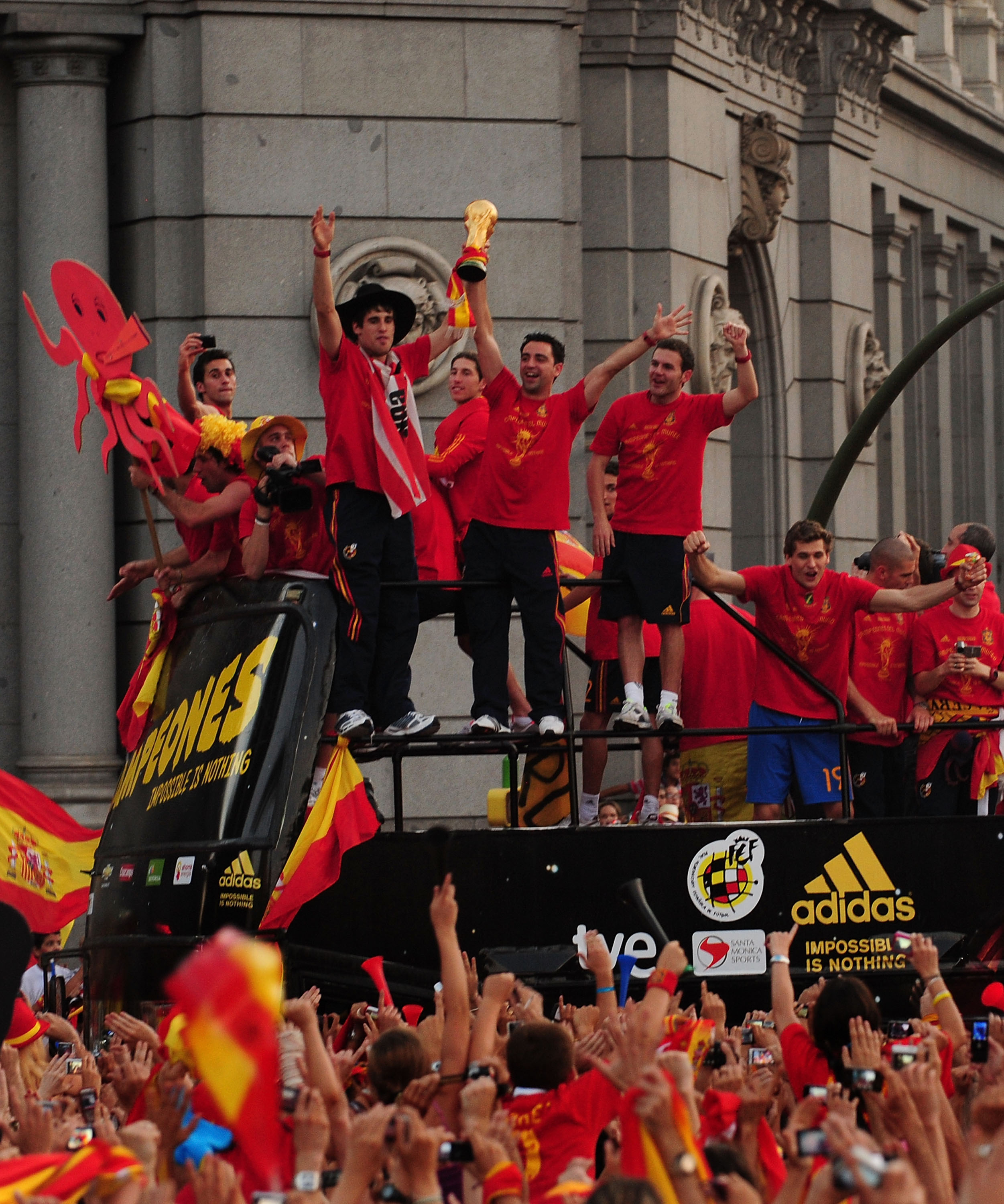 MADRID, SPAIN - JULY 12: Xavi Hernandez holds aloft the FIFA World Cup to the crowds gathered in Plaza Cibeles on July 12, 2010 in Madrid, Spain after Spain won the FIFA World Cup.  (Photo by Denis Doyle/Getty Images)