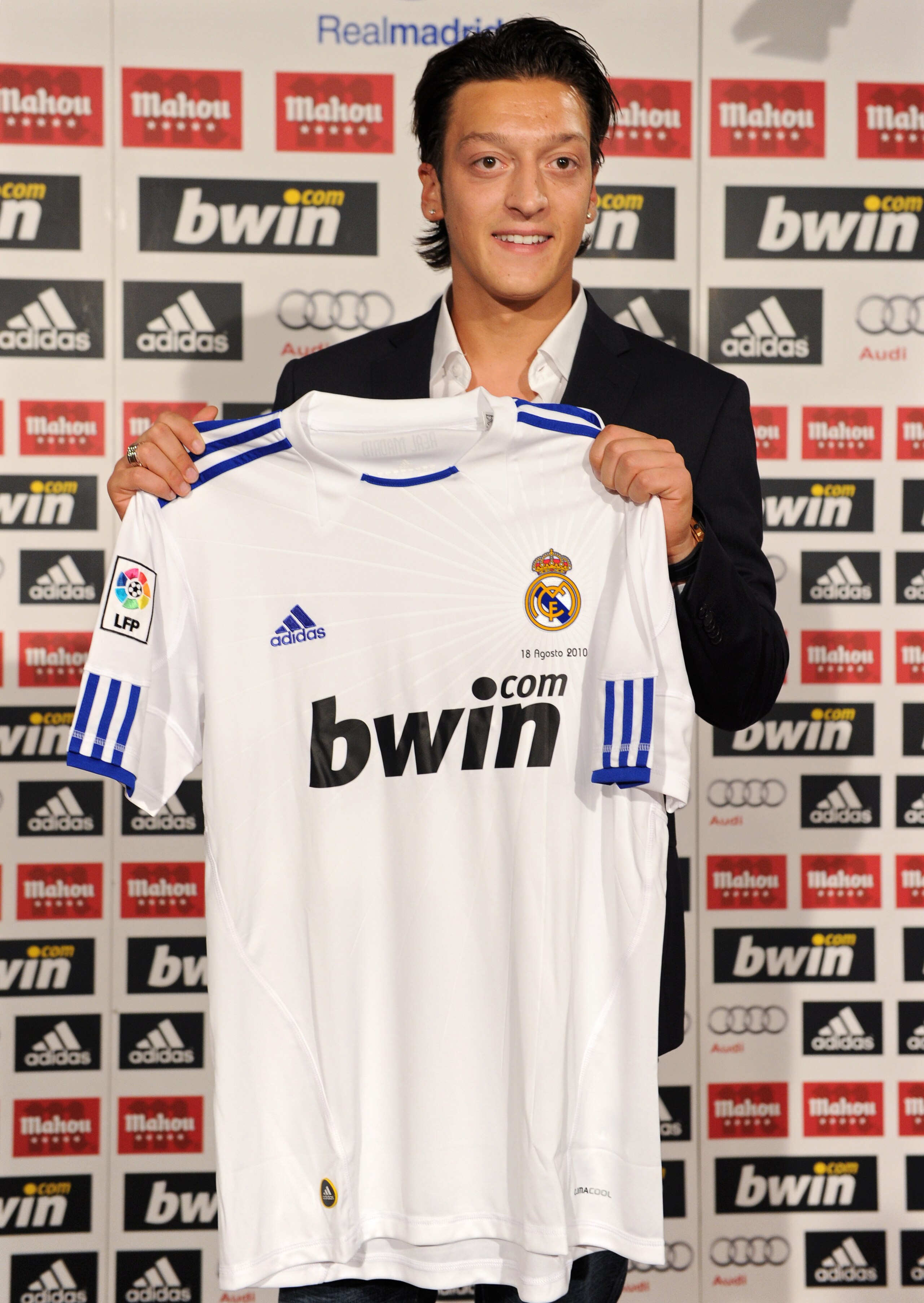 MADRID, SPAIN - AUGUST 18: New signing Mesut Ozil poses with a Real Madrid shirt during his presentation as new Real Madrid player at the Estadio Santiago Bernabeu on August 18, 2010 in Madrid, Spain. (Photo by Jasper Juinen/Getty Images) MADRID, SPAIN - AUGUST 18: New signing Mesut Ozil poses with a Real Madrid shirt during his presentation as new Real Madrid player at the Estadio Santiago Bernabeu on August 18, 2010 in Madrid, Spain. (Photo by Jasper Juinen/Getty Images)