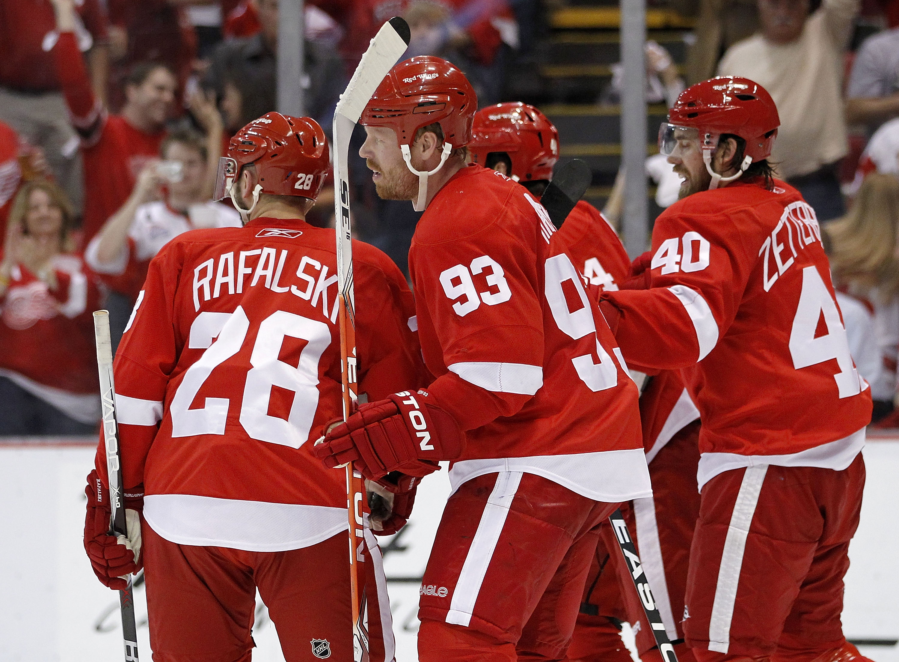 DETROIT - MAY 06:  Johan Franzen #93 of the Detroit Red Wings celebrates with Brian Rafalski #28 and Henrik Zetterberg #40 after his third period and fourth goal of the game while playing the San Jose Sharks in Game Four of the Western Conference Semifina