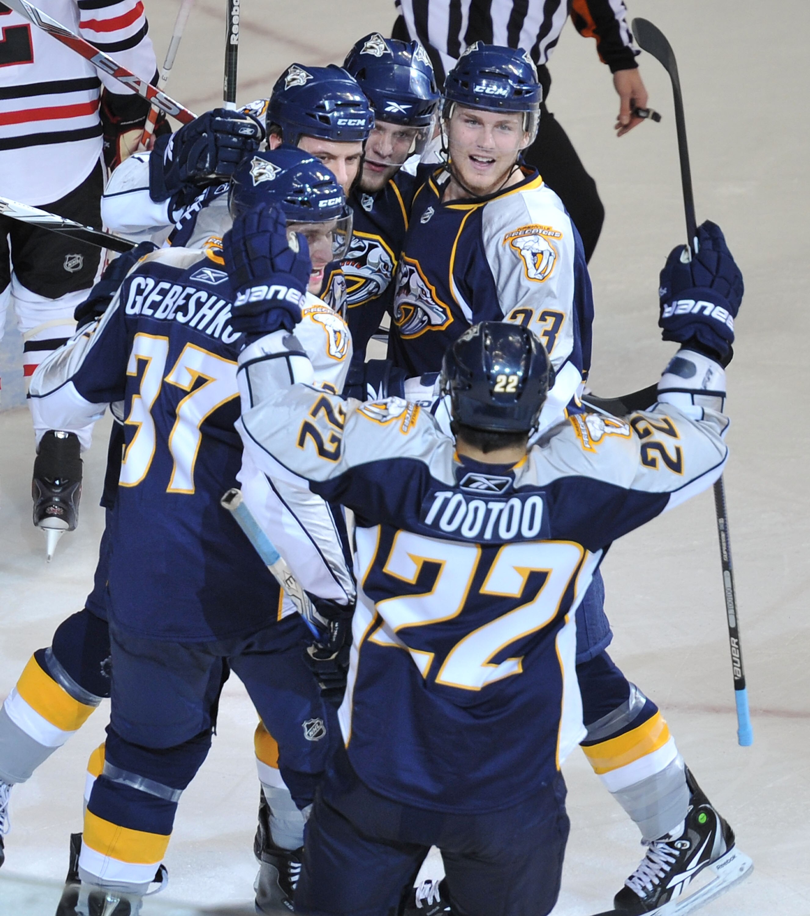 NASHVILLE, TN - APRIL 26:  Jordin Tootoo #22 , Denis Grebeshkov #37, and Colin Wilson #33 of the Nashville Predators celebrate with teammates after scoring a goal against the Chicago Blackhawks in Game Six of the Western Conference Quarterfinals during th