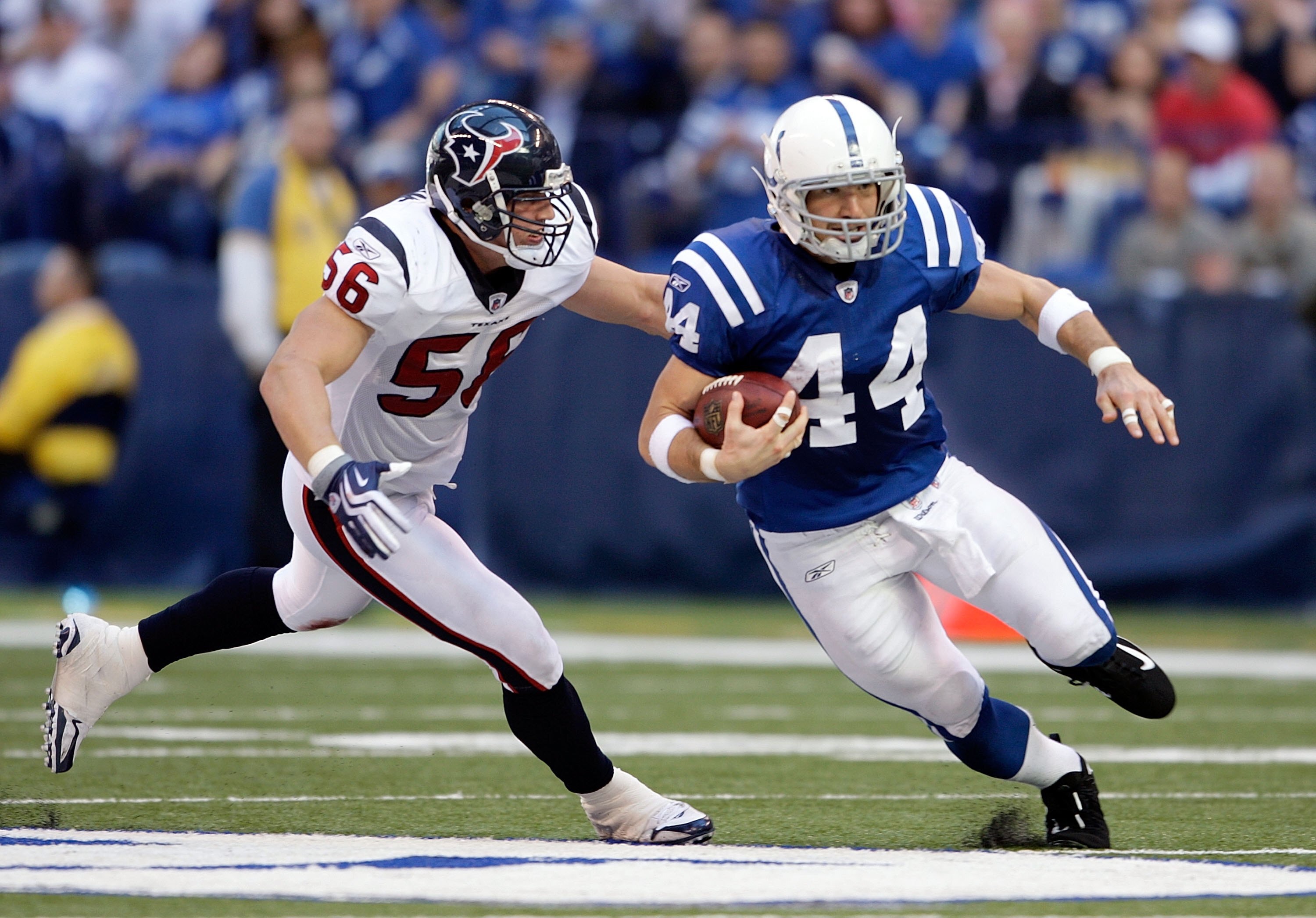 INDIANAPOLIS - NOVEMBER 8:  Dallas Clark #44 of the Indianapolis Colts runs with the ball while defended by Brian Cushing #56 of the Houston Texans  during the NFL game at Lucas Oil Stadium on November 8, 2009 in Indianapolis, Indiana.The Colts defeated t