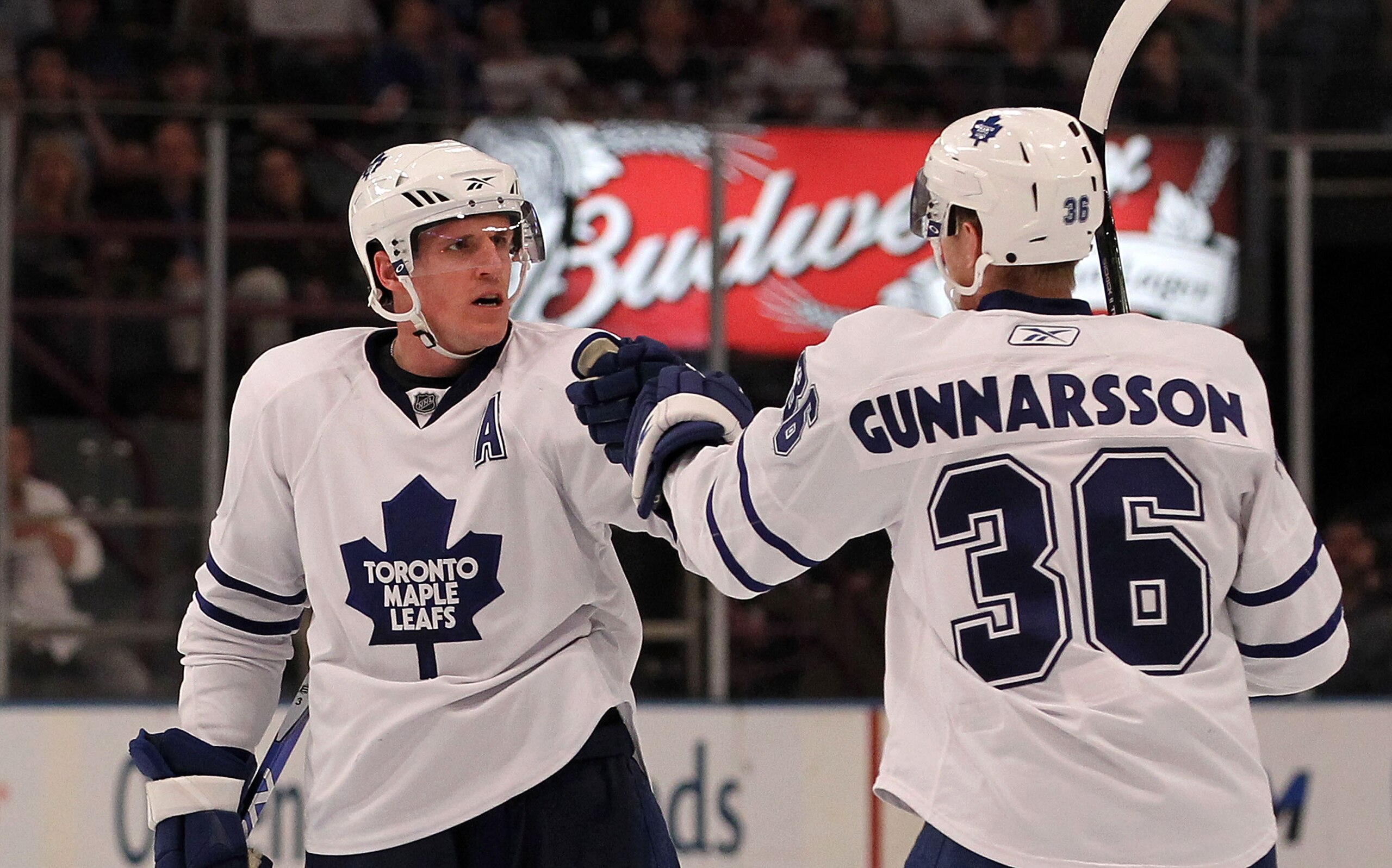 NEW YORK - APRIL 07: Dion Phaneuf #3 (L) of the Toronto Maple Leafs scores his first goal as a Leaf and is met by teammate Carl Gunnarsson #36 in his game against the New York Rangers at Madison Square Garden on April 7, 2010 in New York, New York.  The R