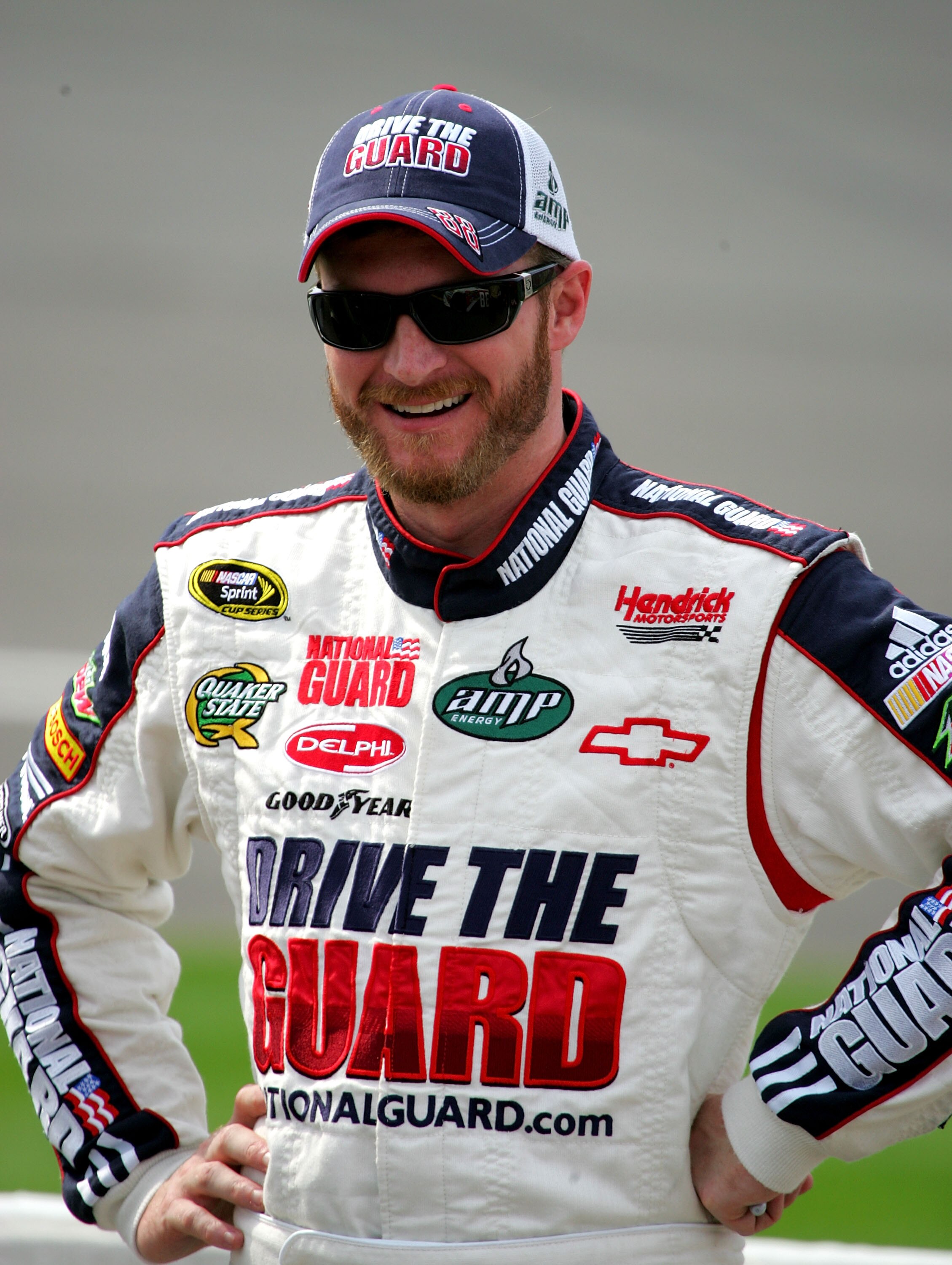 BROOKLYN, MI - AUGUST 13:  Dale Earnhardt Jr., driver of the #88National Guard Drive the Guard/AMP Energy Chevrolet stands on pit road during qualifying for the NASCAR Sprint Cup Series CARFAX 400 at Michigan International Speedway on August 13, 2010 in B