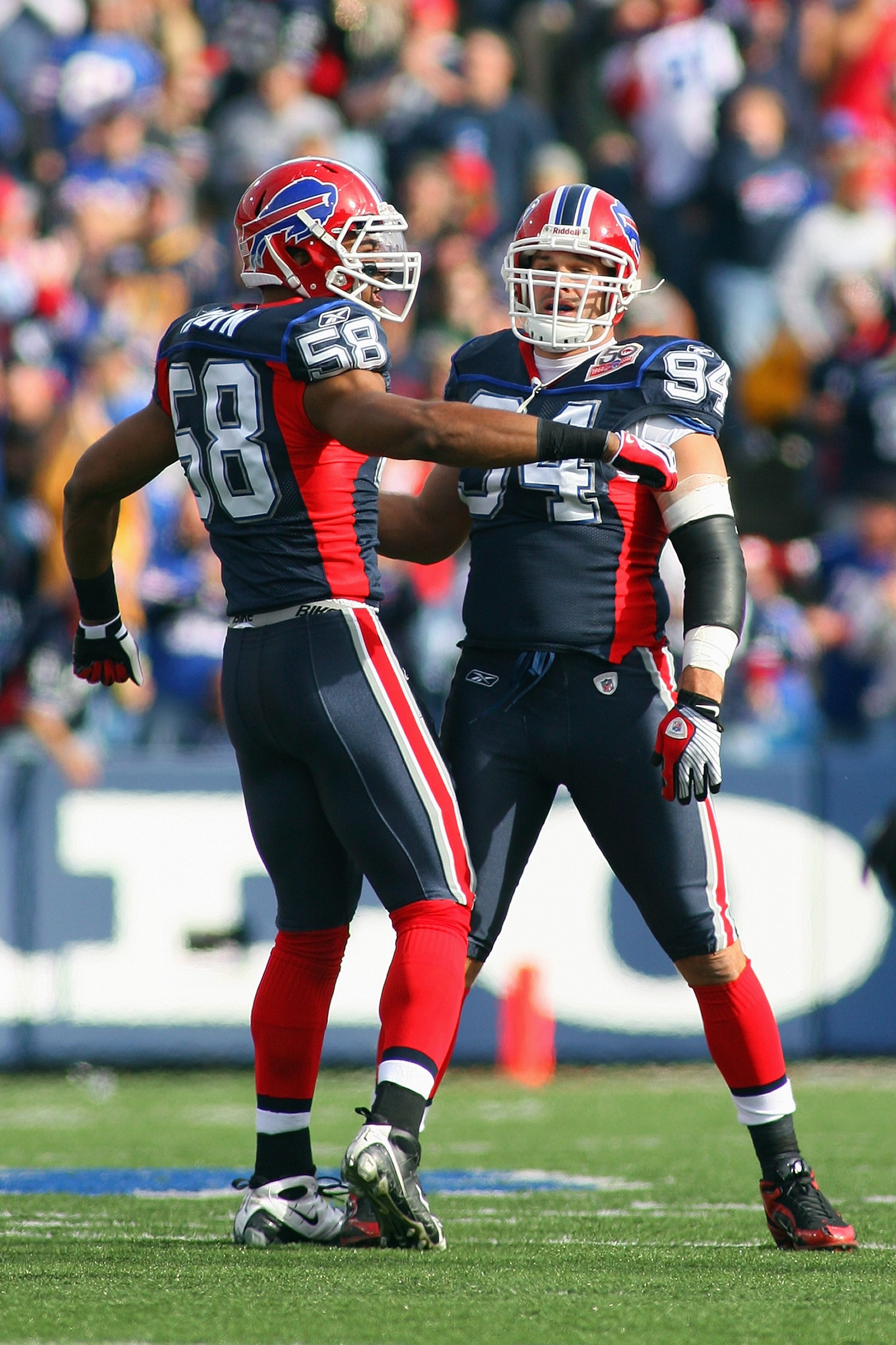 ORCHARD PARK, NY - NOVEMBER 01:  Aaron Maybin #58 and Aaron Schobel #94 of the Buffalo Bills meet on the field during the game against the Houston Texans at Ralph Wilson Stadium on November 1, 2009 in Orchard Park, New York. Houston won 31-10. (Photo by R