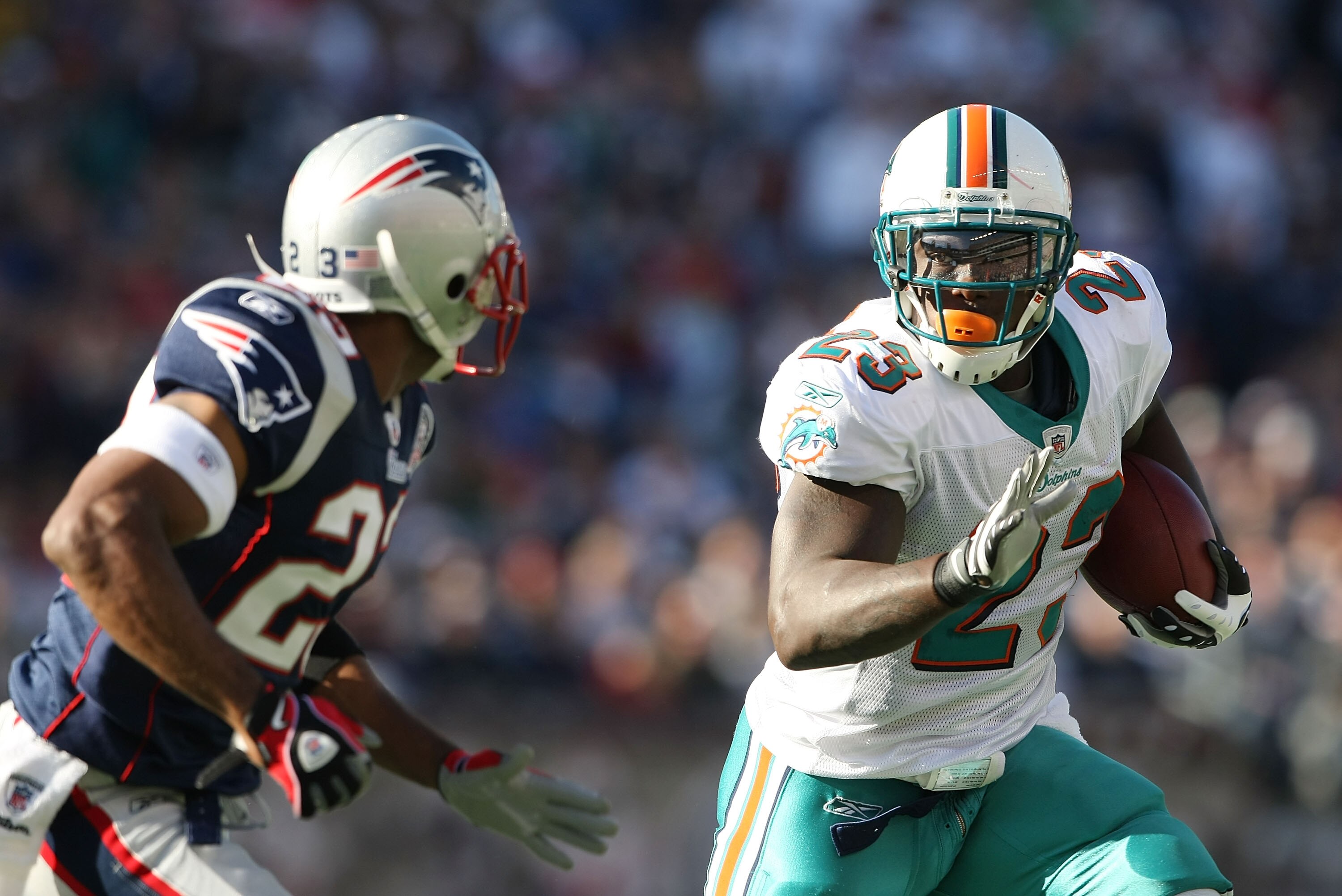 FOXBORO, MA - NOVEMBER 08:  Ronnie Brown #23 of the Miami Dolphins carries the ball as Leigh Bodden #23  of the New England Patriots defends on November 8, 2009 at Gillette Stadium in Foxboro, Massachusetts.  (Photo by Elsa/Getty Images)