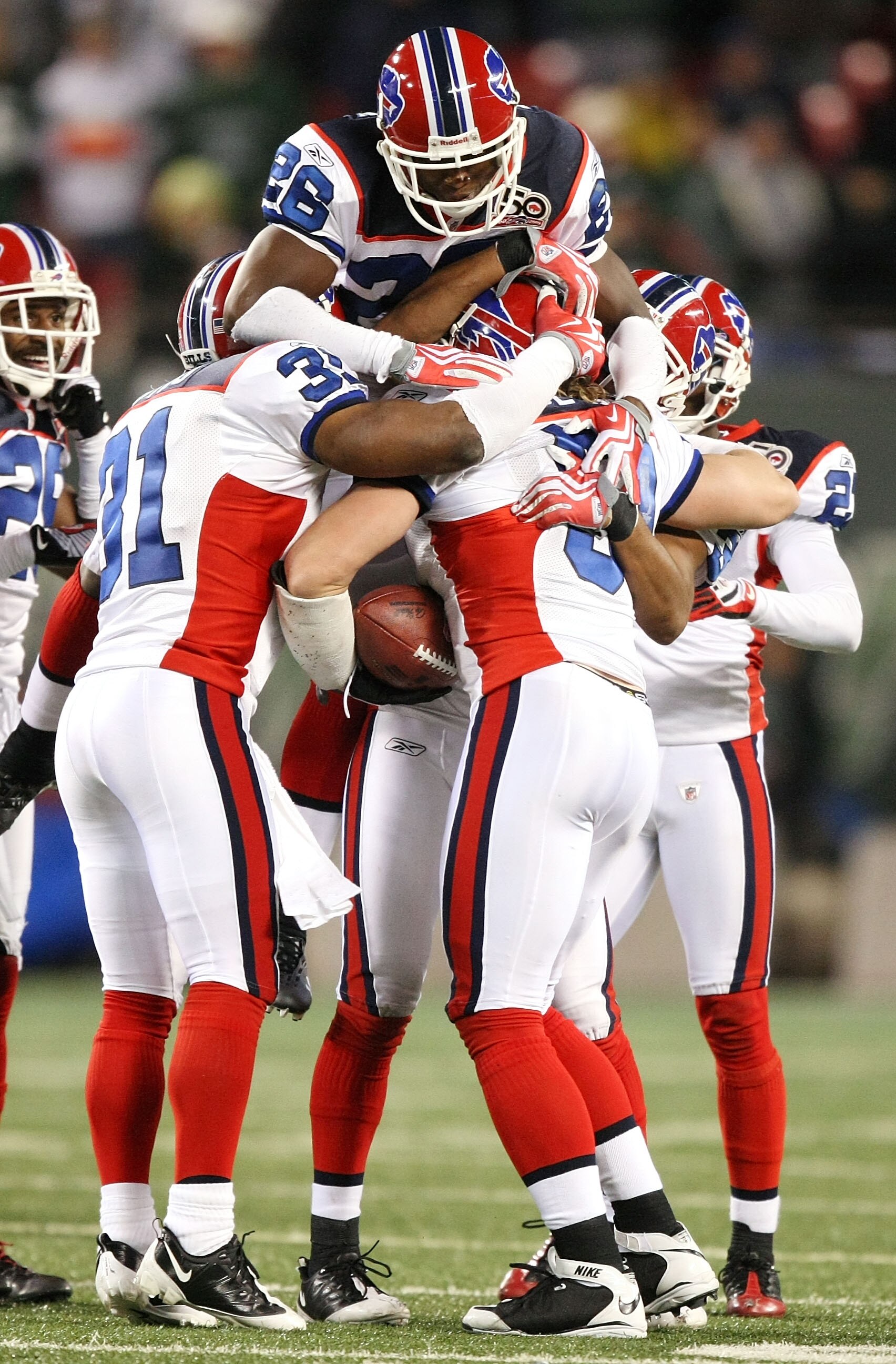 EAST RUTHERFORD, NJ - OCTOBER 18:  Paul Posluszny #51 of the Buffalo Bills is met by Ashton Youboty #26 and his teammates after intercepting the ball in overtime against the New York Jets 16-13 on October 18, 2009 at Giants Stadium in East Rutherford, New