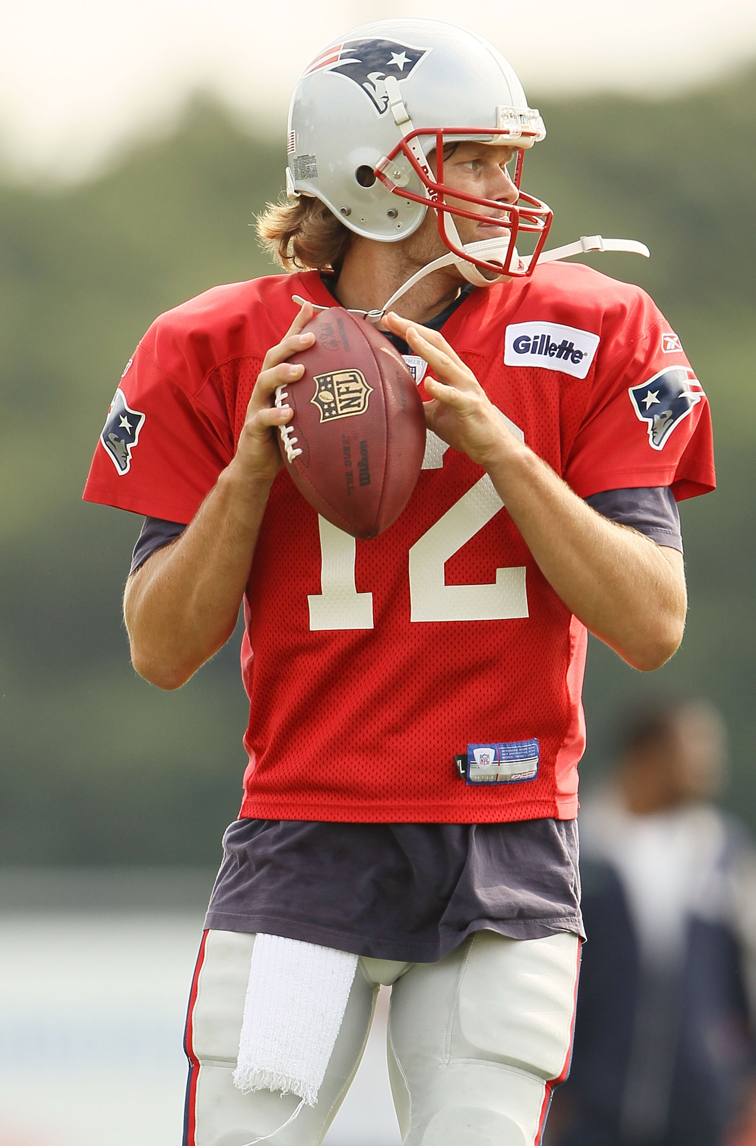 FOXBORO, MA - AUGUST 02:  Quarterback Tom Brady #12 of the New England Patriots looks to pass the ball during training camp on August 2, 2010 at Gillette Stadium in Foxboro, Massachusetts.  (Photo by Elsa/Getty Images)