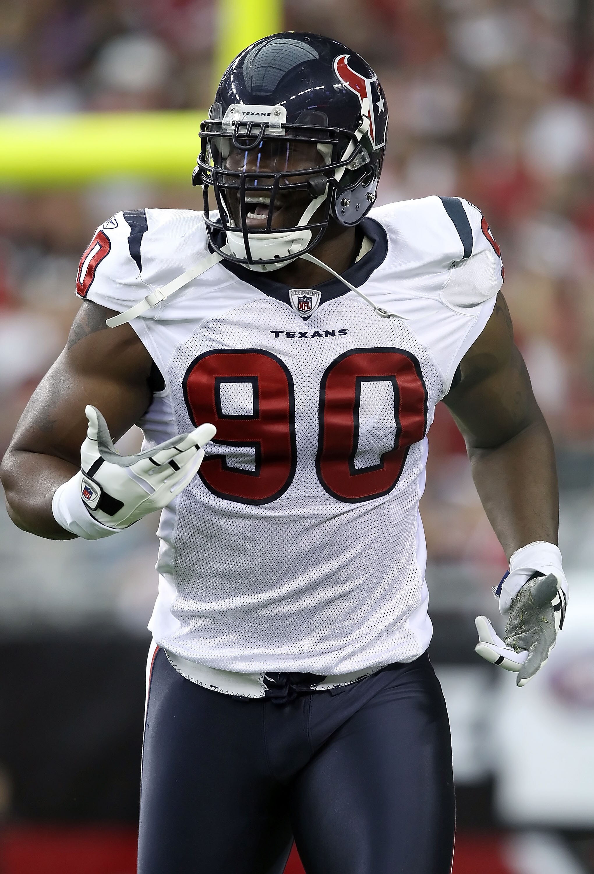 GLENDALE, AZ - AUGUST 14:  Defensive end Mario Williams #90 of the Houston Texans celebrates after a first quarter sack agianst the Arizona Cardinals during preseason NFL game at the University of Phoenix Stadium on August 14, 2010 in Glendale, Arizona.