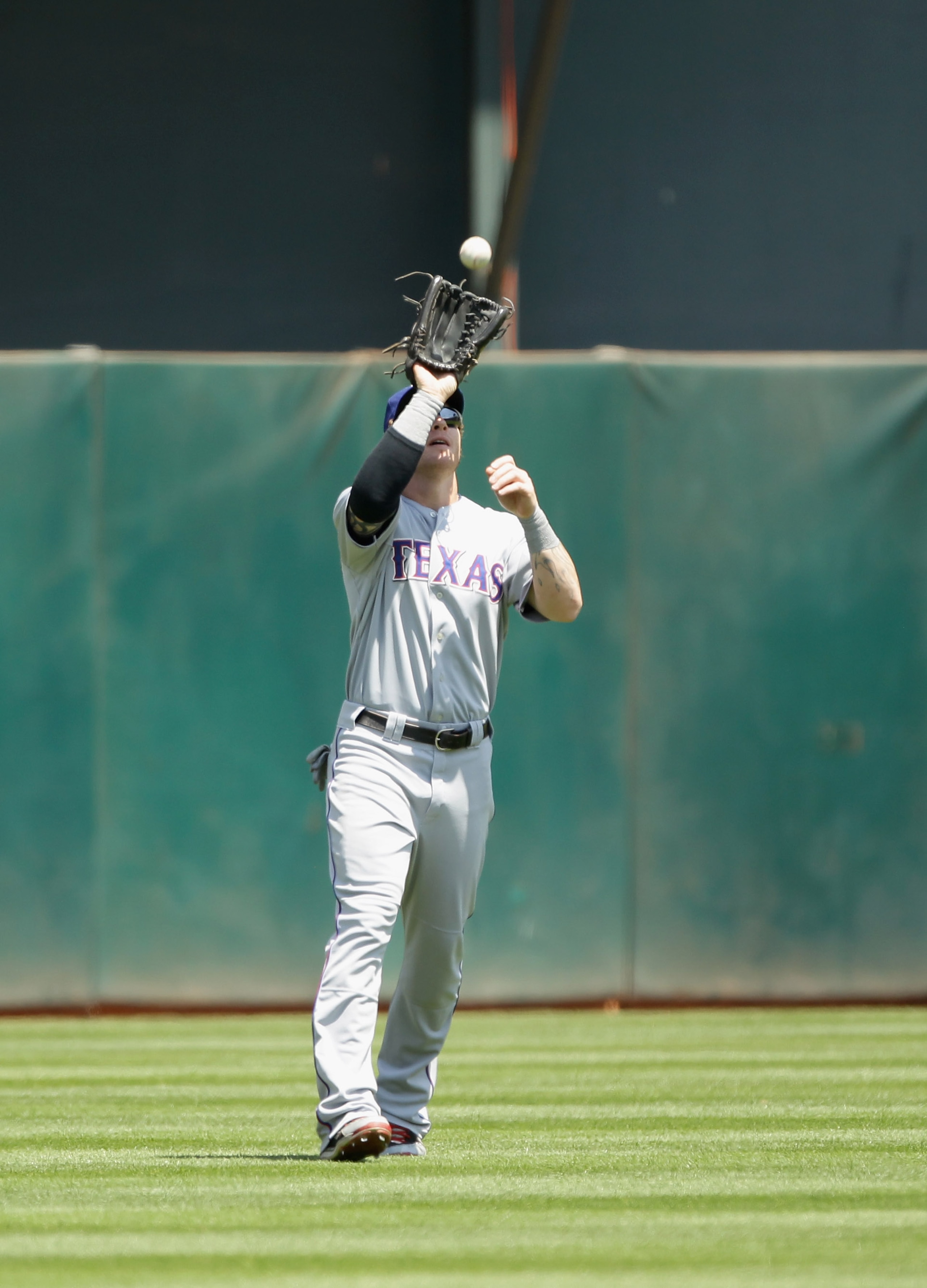 OAKLAND, CA - AUGUST 07: Josh Hamilton #32 of the Texas Rangers catches a fly ball hit by Kurt Suzuki #8 of the Oakland Athletics at the Oakland-Alameda County Coliseum on August 7, 2010 in Oakland, California. (Photo by Ezra Shaw/Getty Images) OAKLAND, CA - AUGUST 07: Josh Hamilton #32 of the Texas Rangers catches a fly ball hit by Kurt Suzuki #8 of the Oakland Athletics at the Oakland-Alameda County Coliseum on August 7, 2010 in Oakland, California. (Photo by Ezra Shaw/Getty Images)