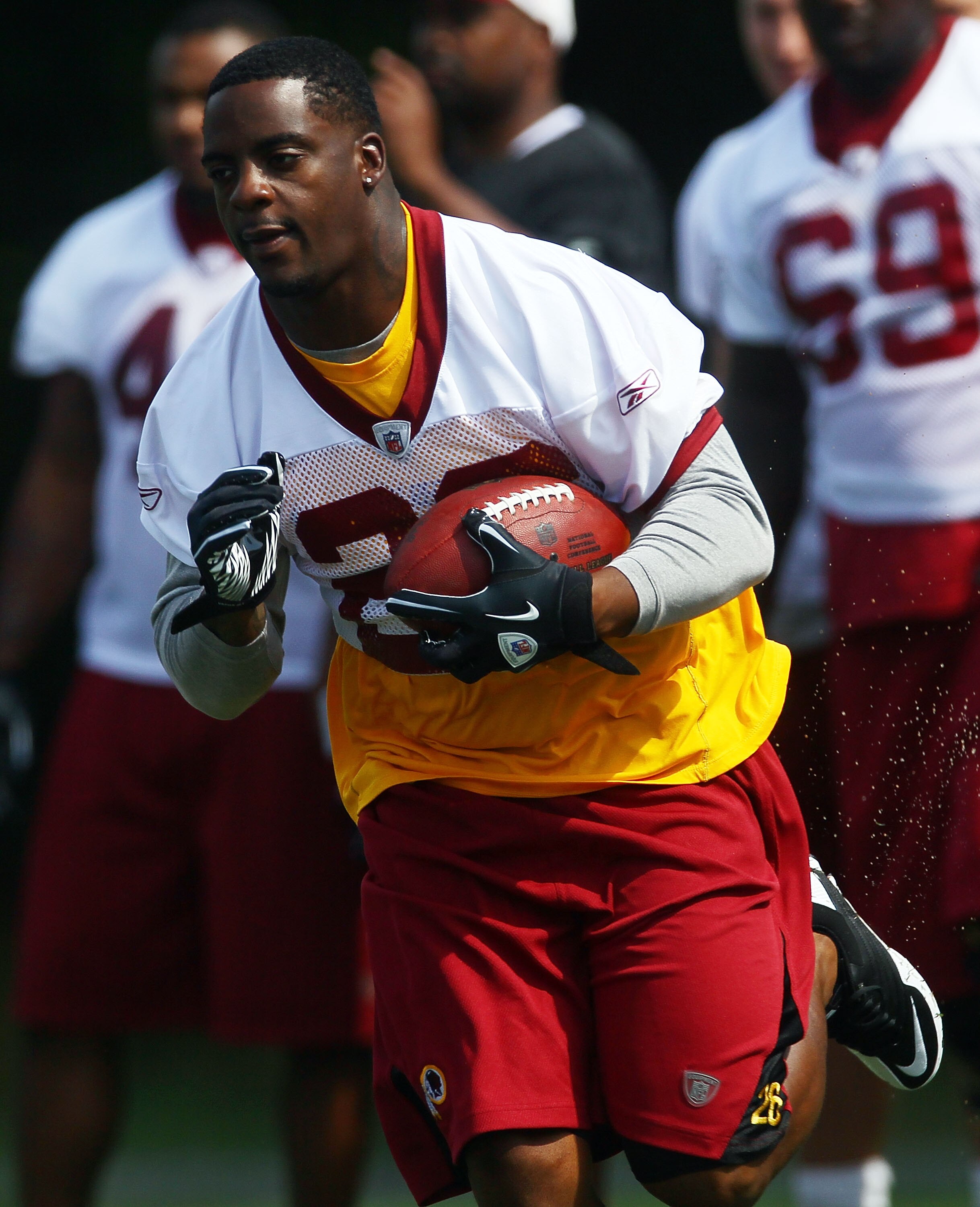ASHBURN, VA - JULY 29:  Running back Clinton Portis #26 of the Washington Redskins carries the ball during drills on the first day of training camp July 29, 2010 in Ashburn, Virginia.  (Photo by Win McNamee/Getty Images)