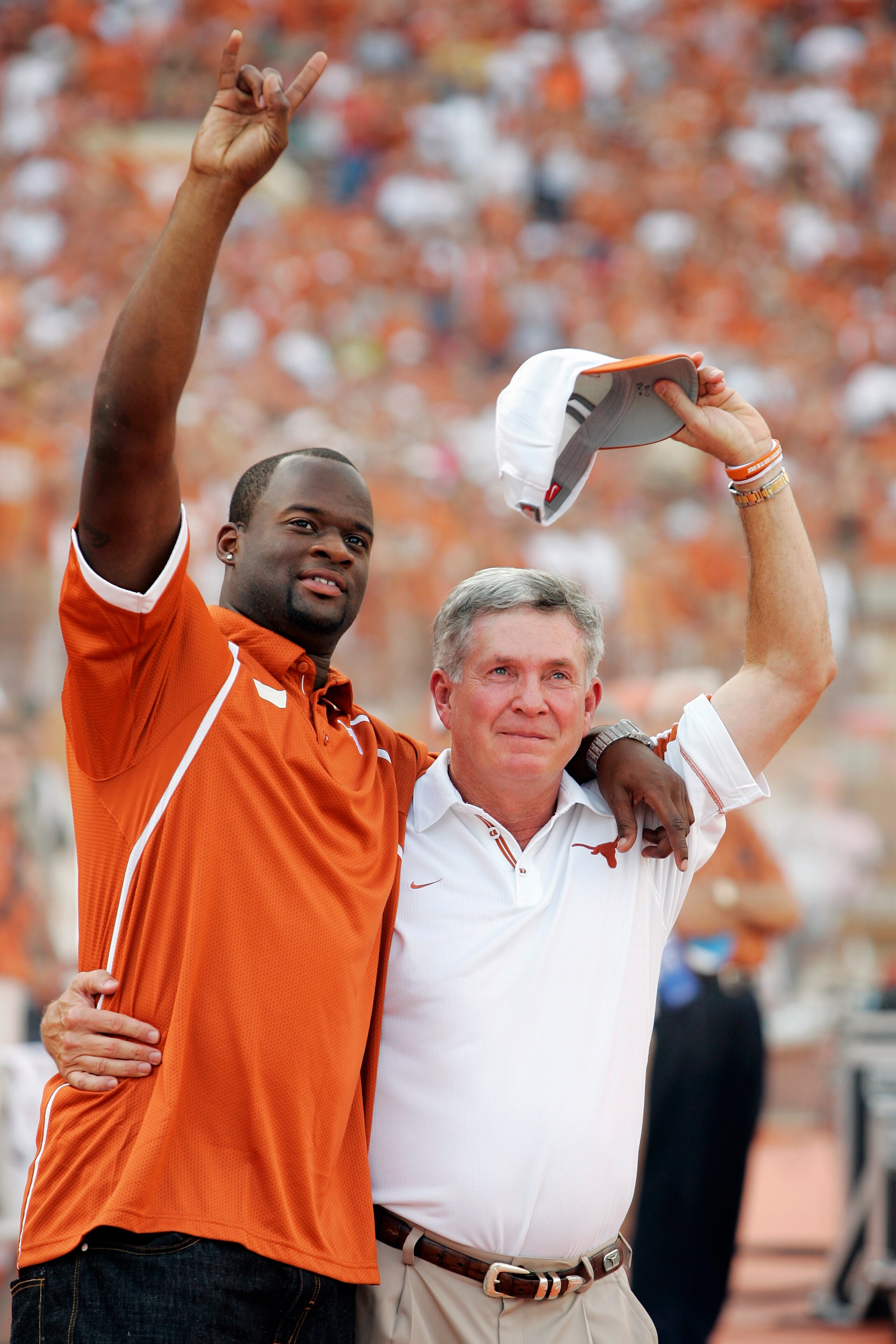 AUSTIN, TX - AUGUST 30:  Quarterback Vince Young of the Tennessee Titans and formerly with the Texas Longhorns hugs coach Mack Brown as his number is retired before a game against the Florida Atlantic Owls at Darrell K Royal-Texas Memorial Stadium on Augu