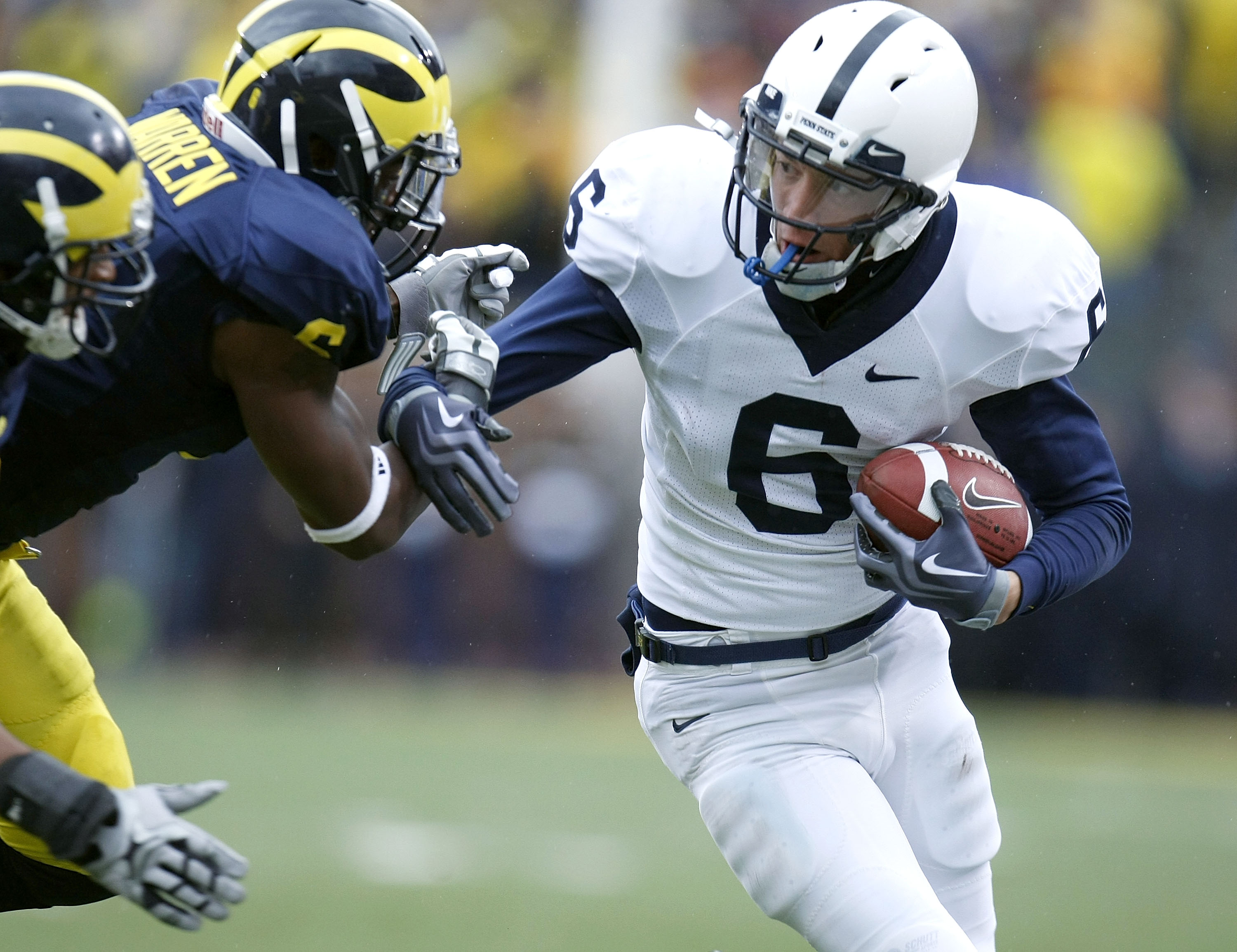 ANN ARBOR, MI - OCTOBER 24: Derek Moye #6 of the Penn State Nittany Lions battles for extra yards after a first quarter catch next to Donovan Warren #6 of the Michigan Wolverines on October 24, 2009 at Michigan Stadium in Ann Arbor, Michigan.  (Photo by G
