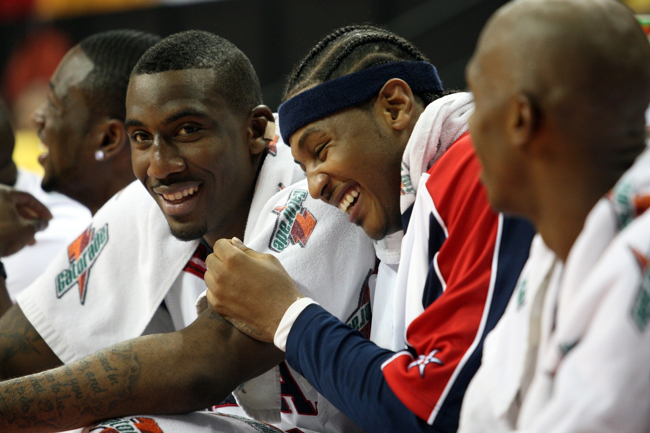 LAS VEGAS - SEPTEMBER 1:  Amare Stoudemire #12 and Carmelo Anthony #15 of the USA laugh as they watch from the bench during the FIBA Americas Championship 2007 Semifinal game at the Thomas & Mack Center September 1, 2007 in Las Vegas, Nevada.  (Photo by J