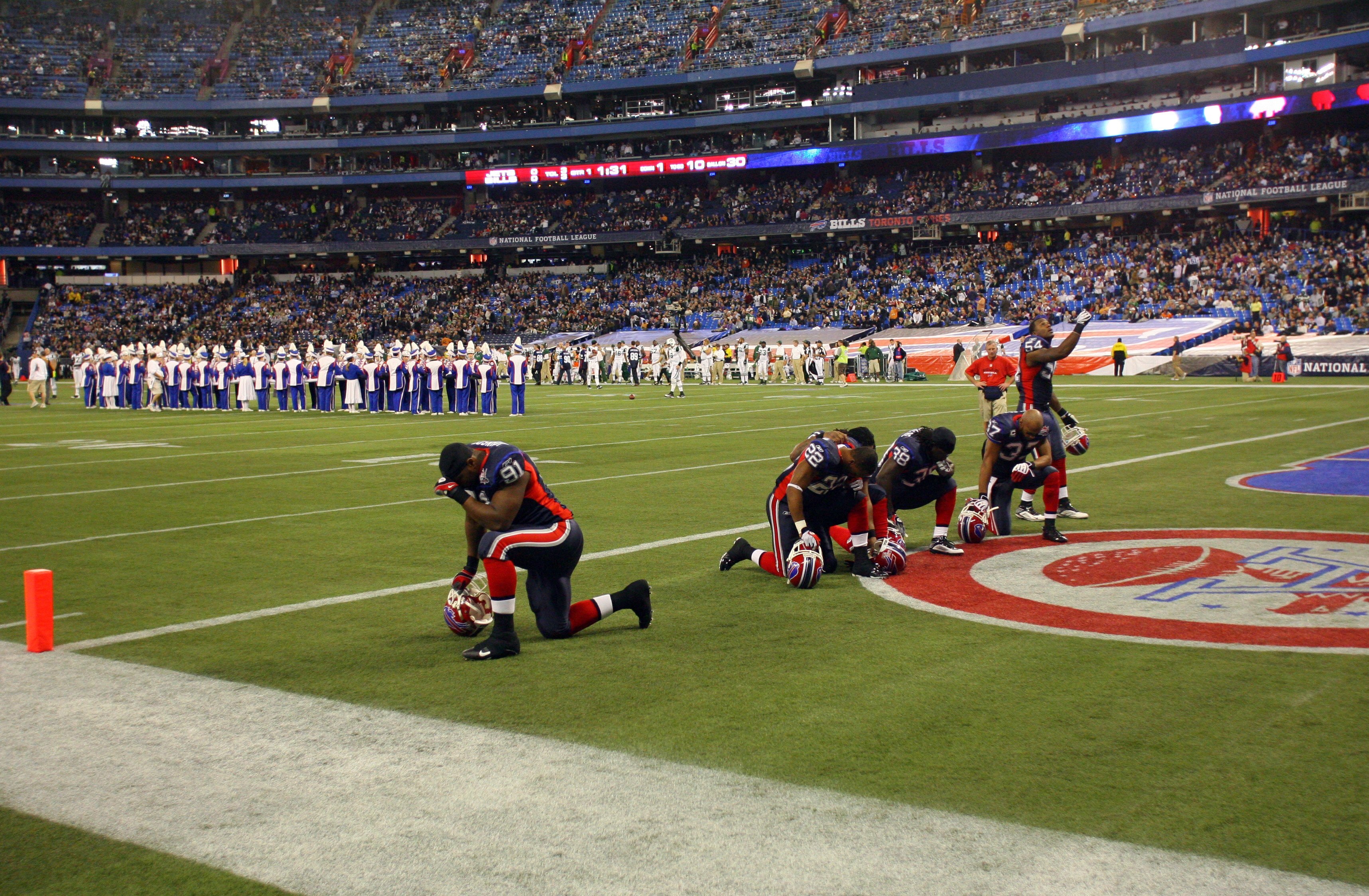 TORONTO - DECEMBER 3:  Members of the Buffalo Bills kneel in the end zone during a break in their NFL game against the New York Jets on December 3, 2009  at Rogers Centre in Toronto, Ontario, Canada. The Jets defeated the Bills 19-13. (Photo by Rick Stewa