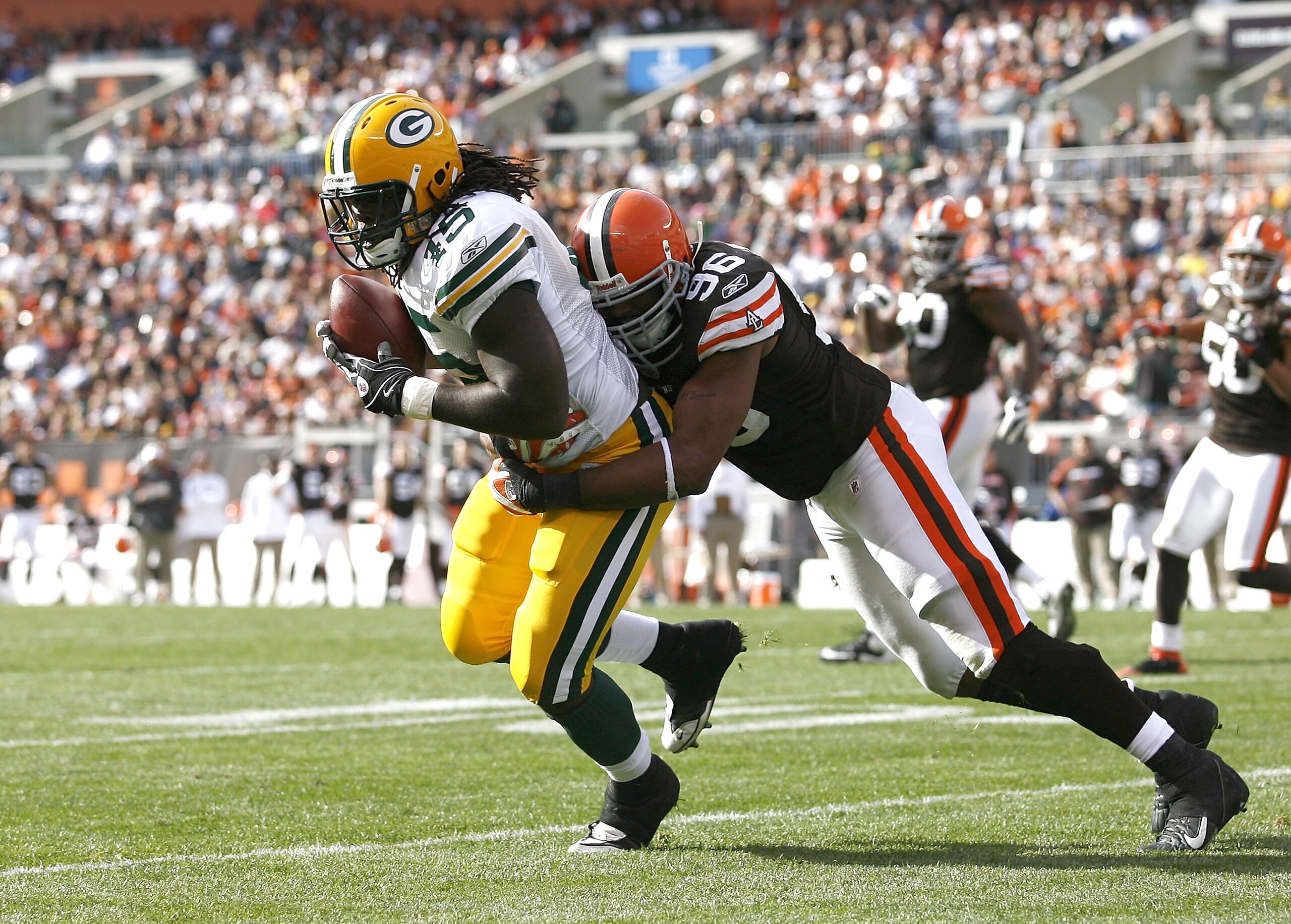 CLEVELAND, OH - OCTOBER 25: Quinn Johnson #45 of the Green Bay Packers makes a catch as he is hit by David Bowens #96of the Cleveland Browns at Cleveland Browns Stadium on October 25, 2009 in Cleveland, Ohio. (Photo by Matt Sullivan/Getty Images) CLEVELAND, OH - OCTOBER 25: Quinn Johnson #45 of the Green Bay Packers makes a catch as he is hit by David Bowens #96of the Cleveland Browns at Cleveland Browns Stadium on October 25, 2009 in Cleveland, Ohio. (Photo by Matt Sullivan/Getty Images)