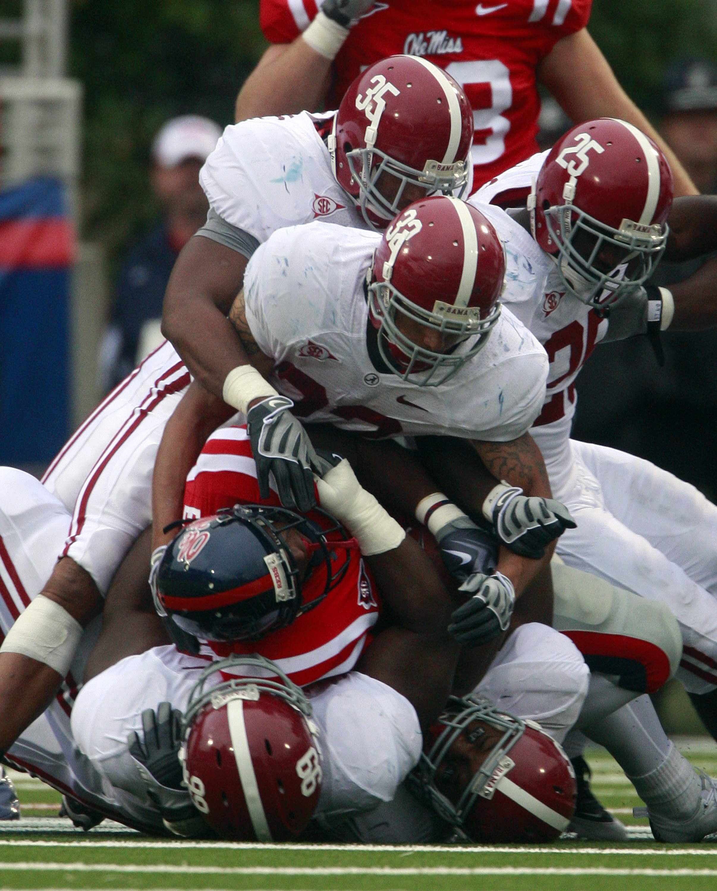 OXFORD, MS - OCTOBER 10:  Defenders Nico Johnson #35, Eryk Anders #32, Rolando McClain #25, Josh Chapman #99 and Luther Davis #96 stop running back Brandon Bolden #34 for a loss during their college football game at Vaught-Hemingway Stadium on October 10,