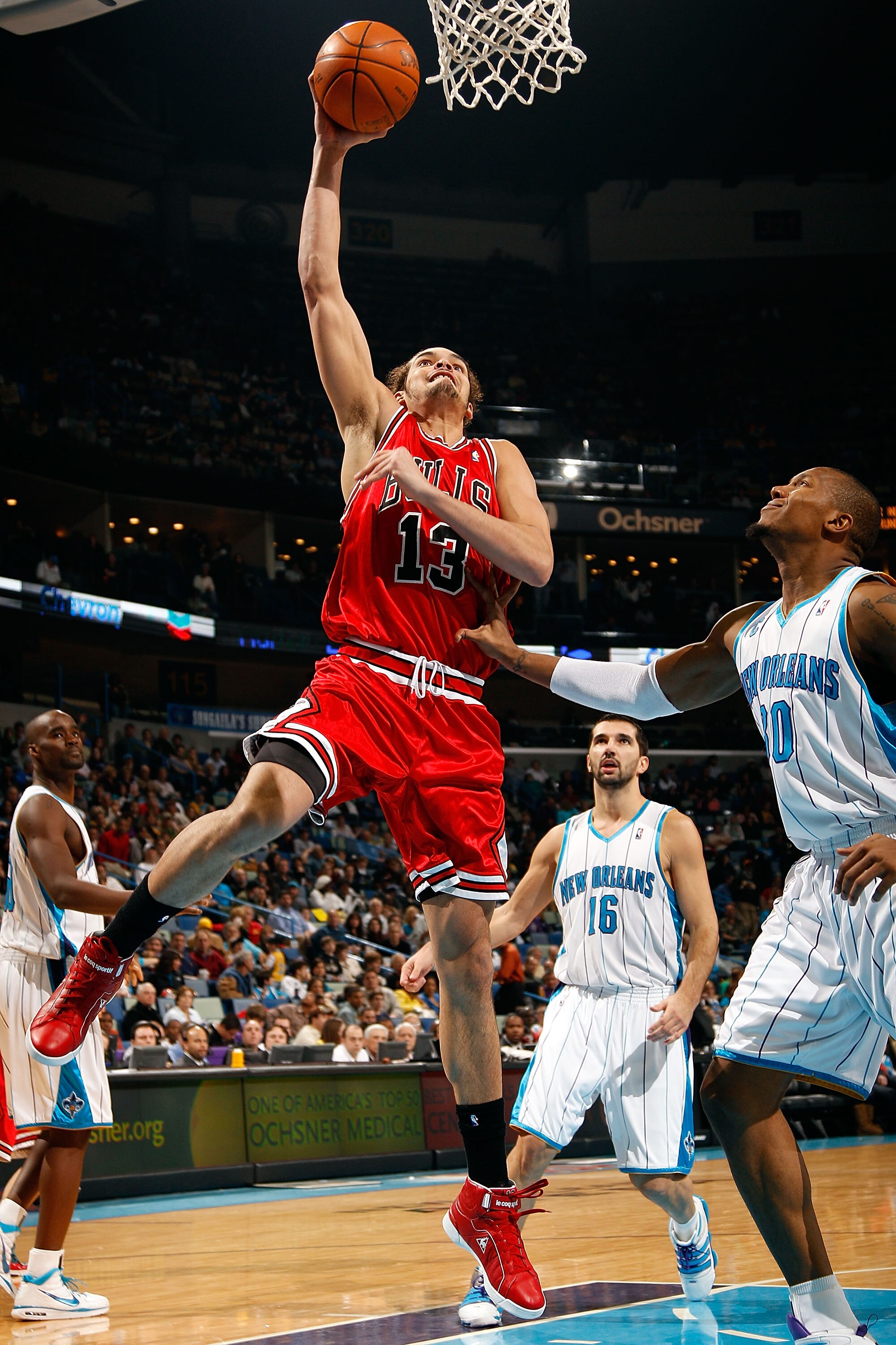 NEW ORLEANS - JANUARY 29:  Joakim Noah #13 of the Chicago Bulls makes a shot over David West #30 of the New Orleans Hornets at the New Orleans Arena on January 29, 2010 in New Orleans, Louisiana.   The Bulls defeated the Hornets 108-106 in overtime.  NOTE