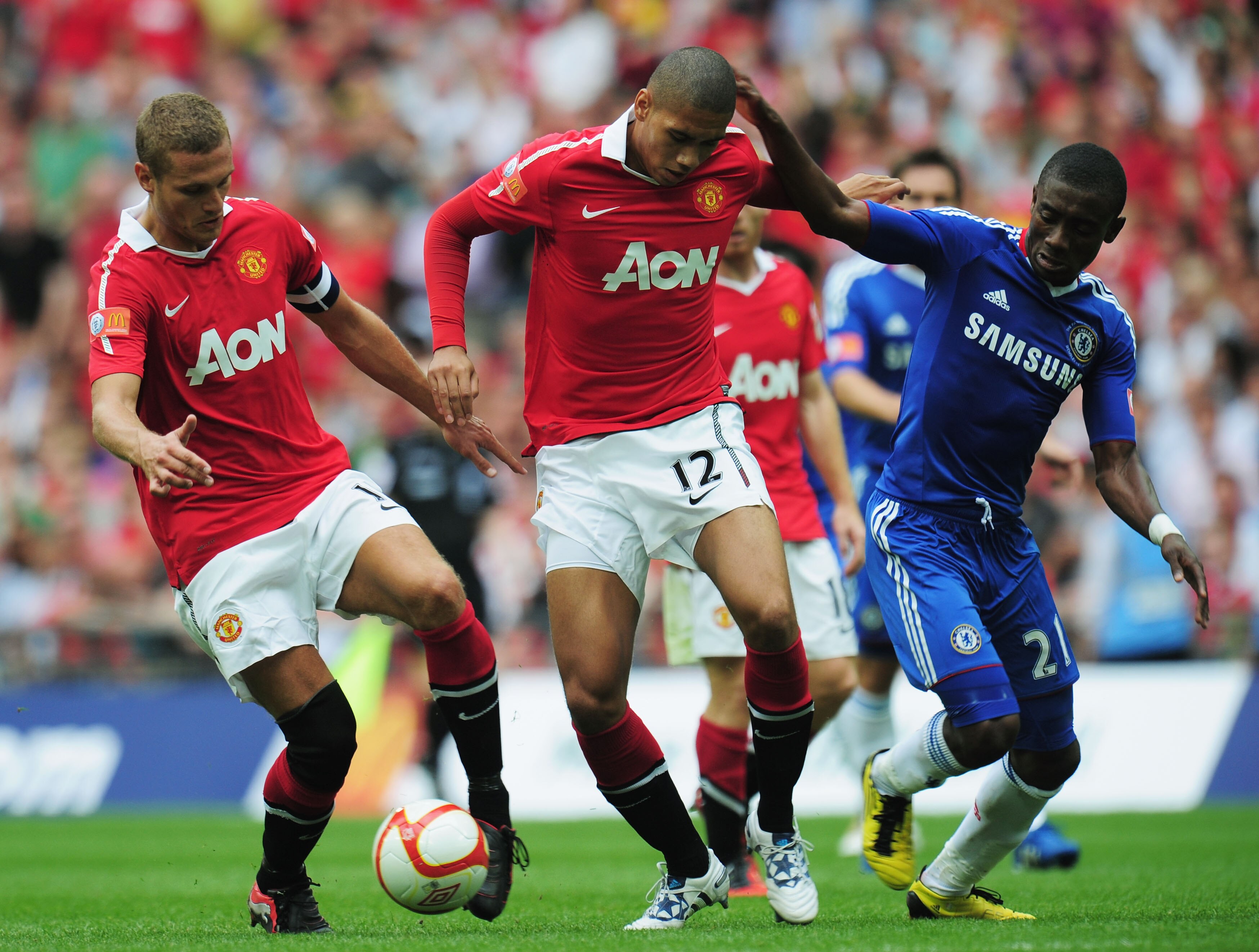 LONDON, ENGLAND - AUGUST 08:  Nemanja Vidic of Manchester United collects the ball from Chris Smalling after he loses the ball under pressure by Salomon Kalou of Chelsea during the FA Community Shield match between Chelsea and Manchester United at Wembley
