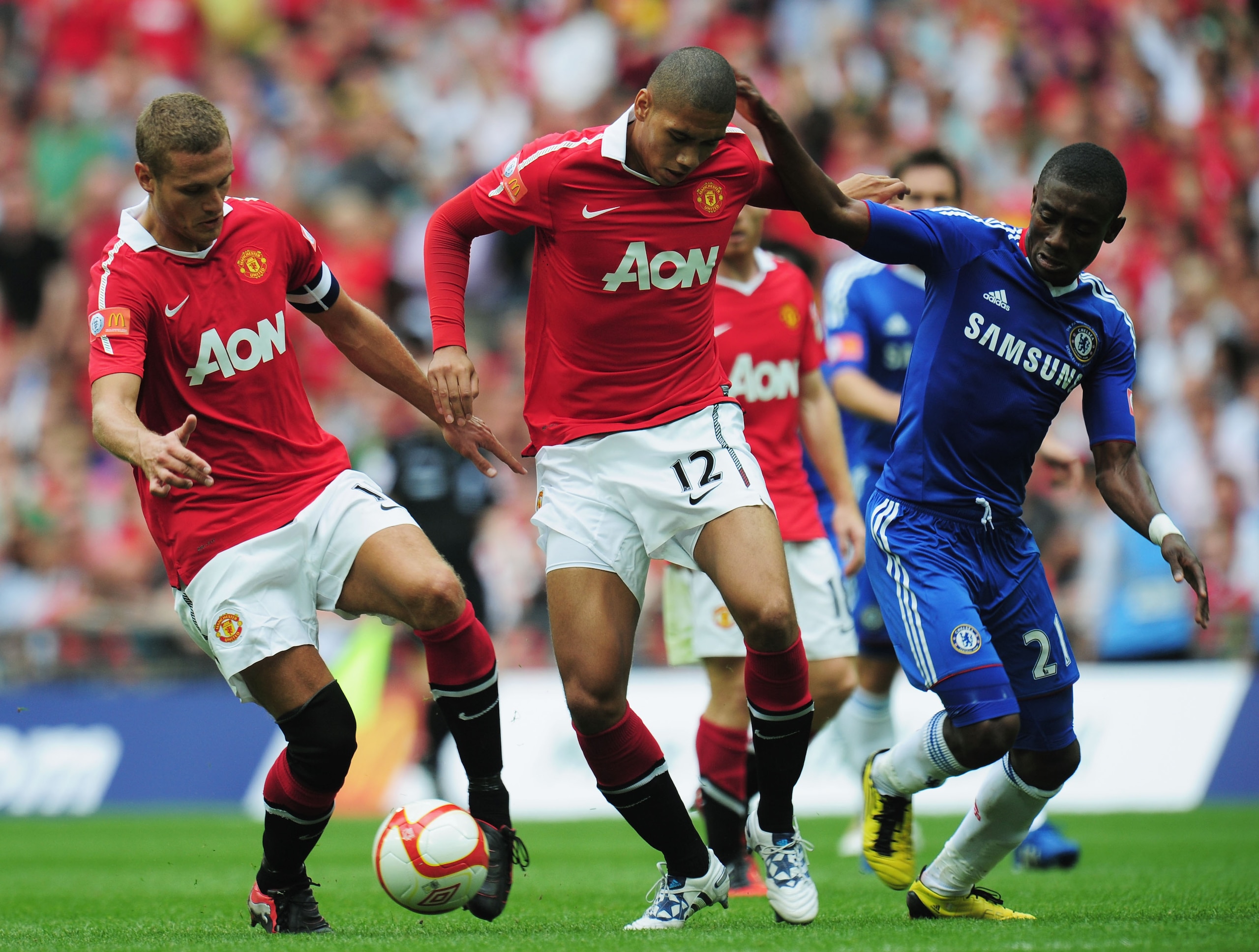 LONDON, ENGLAND - AUGUST 08:  Nemanja Vidic of Manchester United collects the ball from Chris Smalling after he loses the ball under pressure by Salomon Kalou of Chelsea during the FA Community Shield match between Chelsea and Manchester United at Wembley