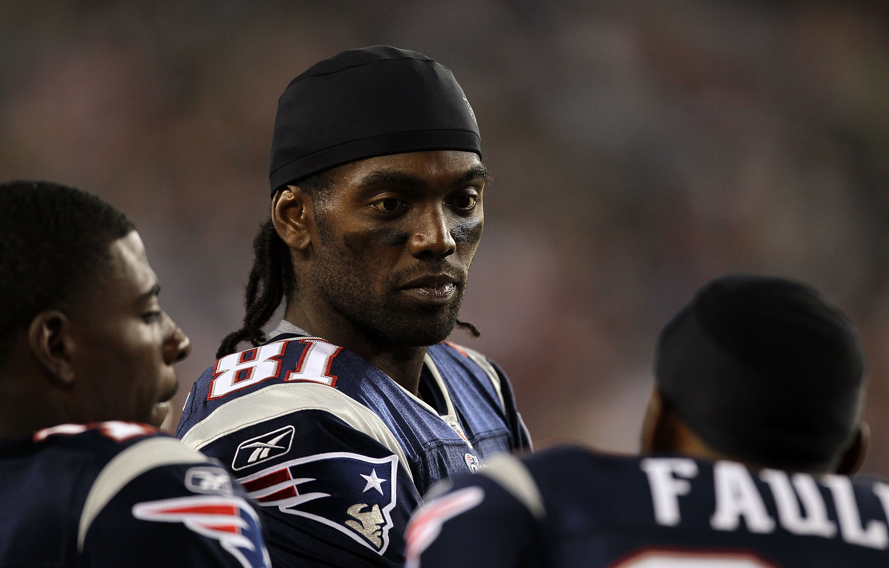 FOXBORO, MA - AUGUST 12: Randy Moss # 81 of the New England Patriots chats with teammates on the sidelines during the preseason game against the New Orleans Saints at Gillette Stadium on August 12, 2010 in Foxboro, Massachusetts. (Photo by Jim Rogash/Gett