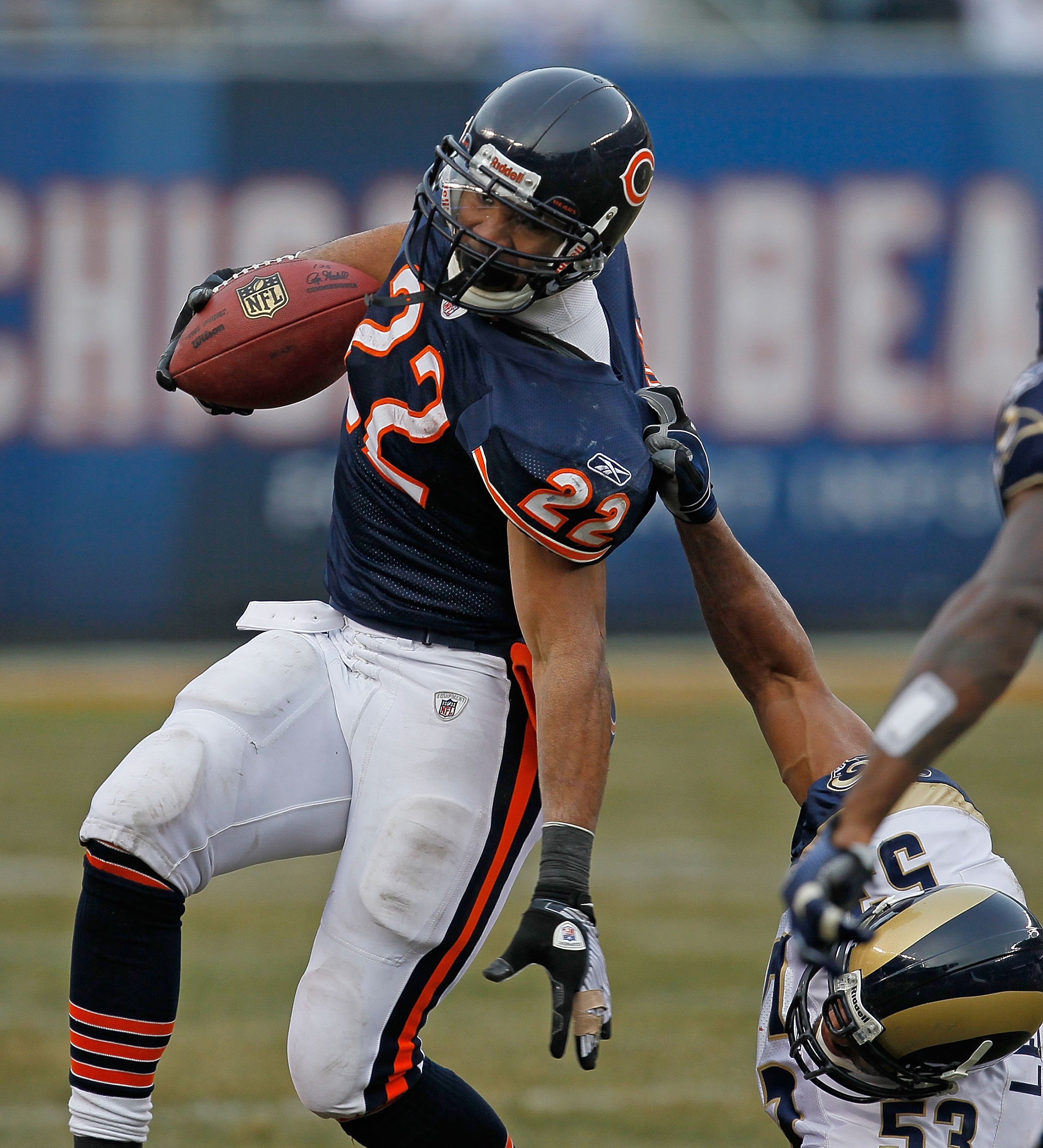 CHICAGO - DECEMBER 06: Matt Forte #22 of the Chicago Bears is brought down by an illegal 'horse-collar' tackle by Paris Lenon #53 of the St. Louis Rams at Soldier Field on December 6, 2009 in Chicago, Illinois. The Bears defeated the Rams 17-9.  (Photo by
