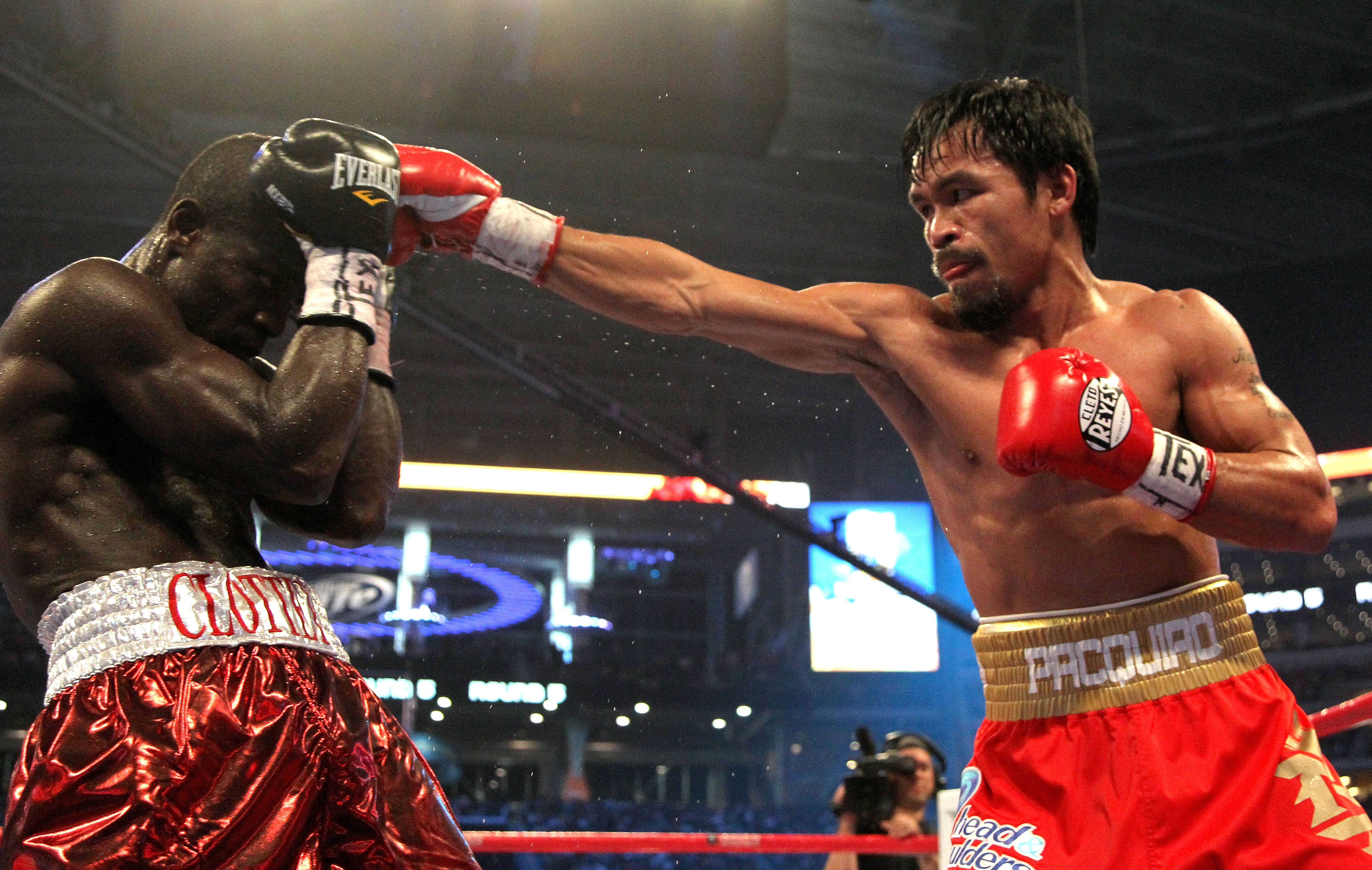 ARLINGTON, TX - MARCH 13:  (R-L) Manny Pacquiao of the Philippines throws a right to the head of Joshua Clottey of Ghana during the WBO welterweight title fight at Cowboys Stadium on March 13, 2010 in Arlington, Texas.  (Photo by Jed Jacobsohn/Getty Image