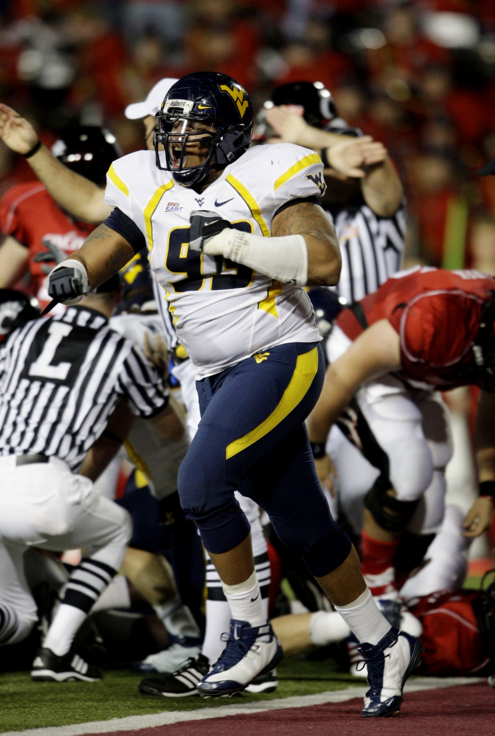 CINCINNATI - NOVEMBER 13:  Scooter Berry #93 of the West Virginia Mountaineers celebrates after a funble recovery on the one yard line in the second quarter of the game against the Cincinnati Bearcats in at Nippert Stadium on November 13, 2009 in Cincinna