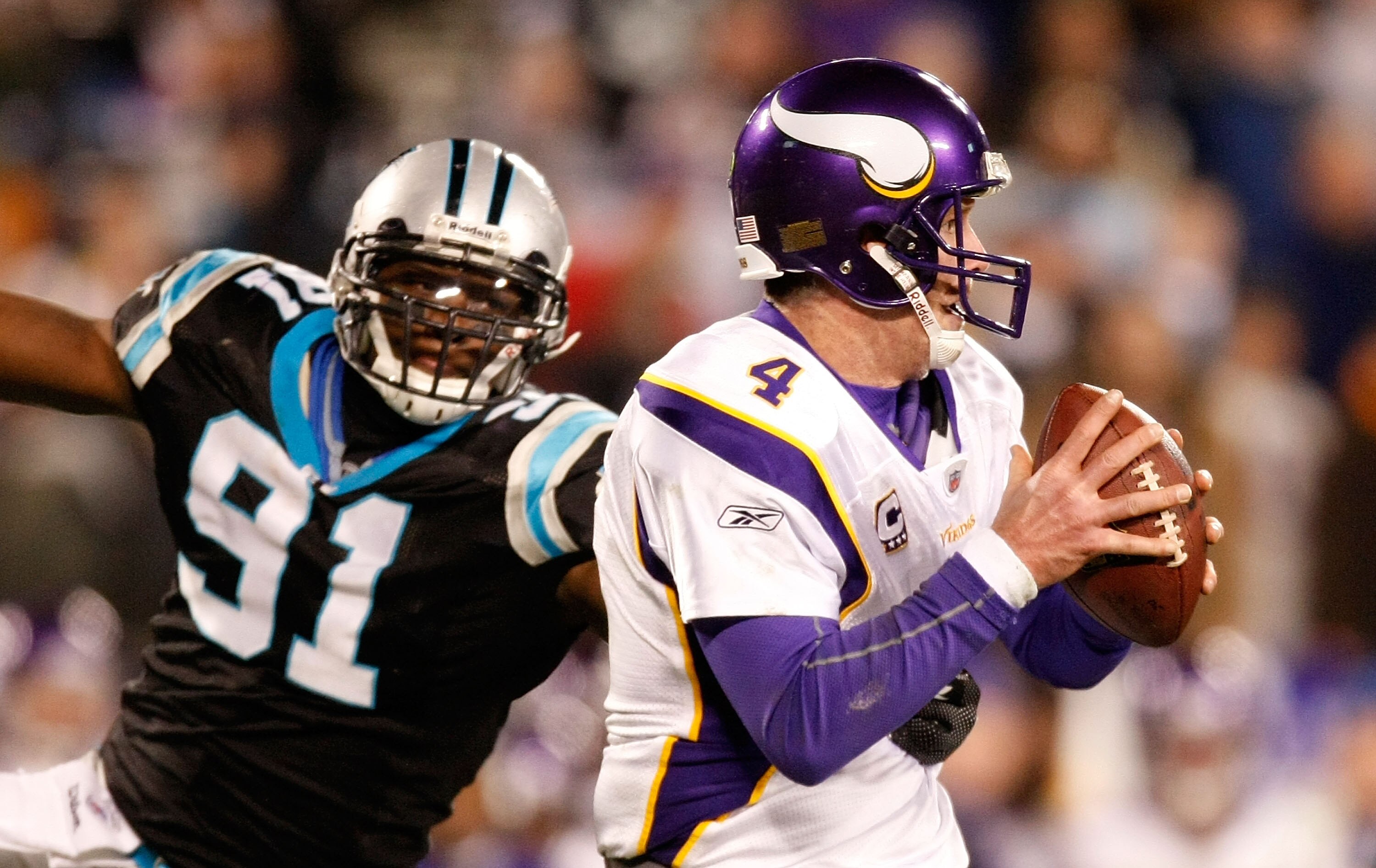 CHARLOTTE, NC - DECEMBER 20:  Quarterback Brett Favre #4 of the Minnesota Vikings is pressured by Everette Brown #91 of the Carolina Panthers at Bank of America Stadium on December 20, 2009 in Charlotte, North Carolina.  (Photo by Kevin C. Cox/Getty Image
