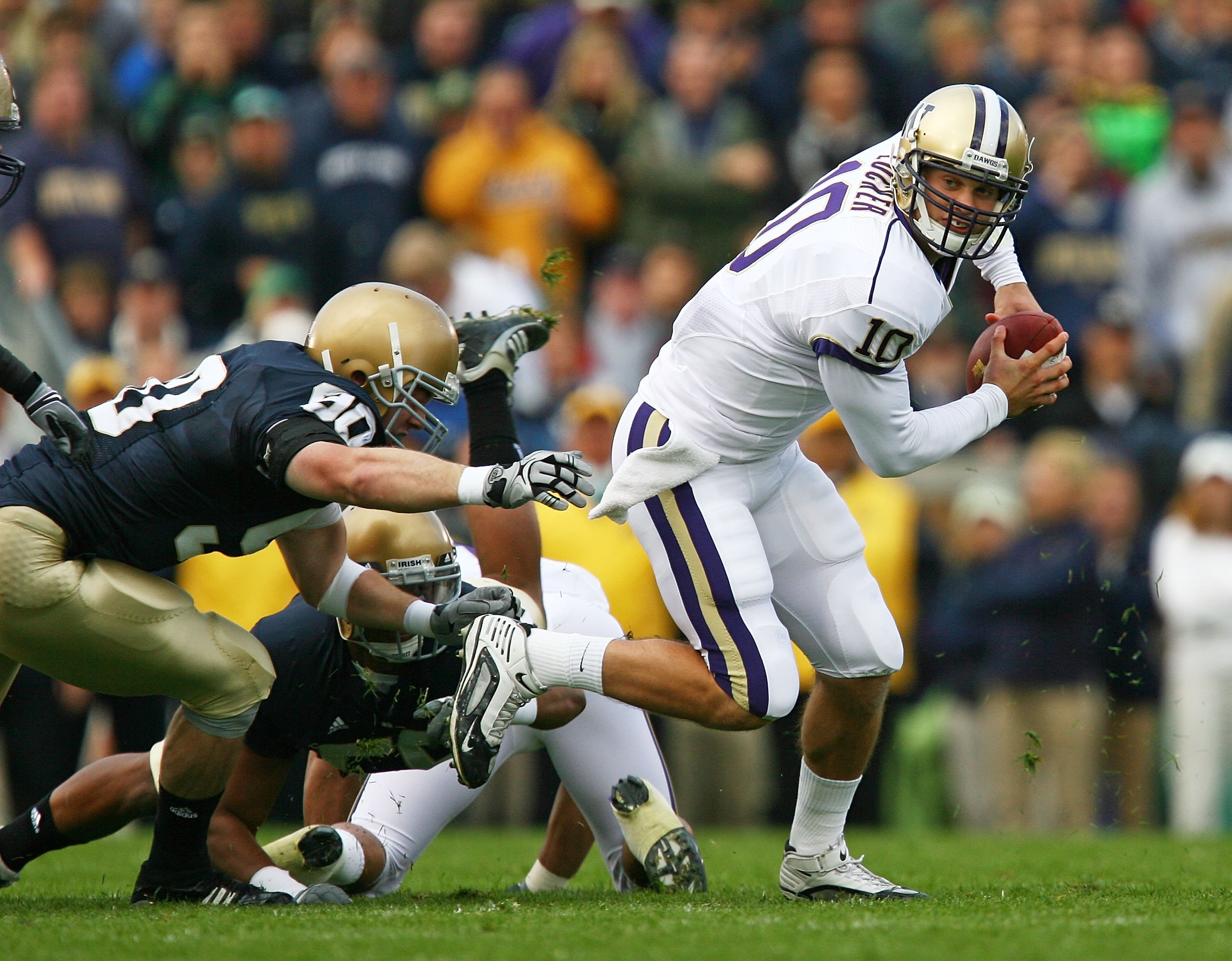 SOUTH BEND, IN - OCTOBER 03: Jake Locker #10 of the Washington Huskies runs away from John Ryan #90 of the Notre Dame Fighting Irish on October 3, 2009 at Notre Dame Stadium in South Bend, Indiana. Notre Dame defeated Washington 37-30. (Photo by Jonathan 
