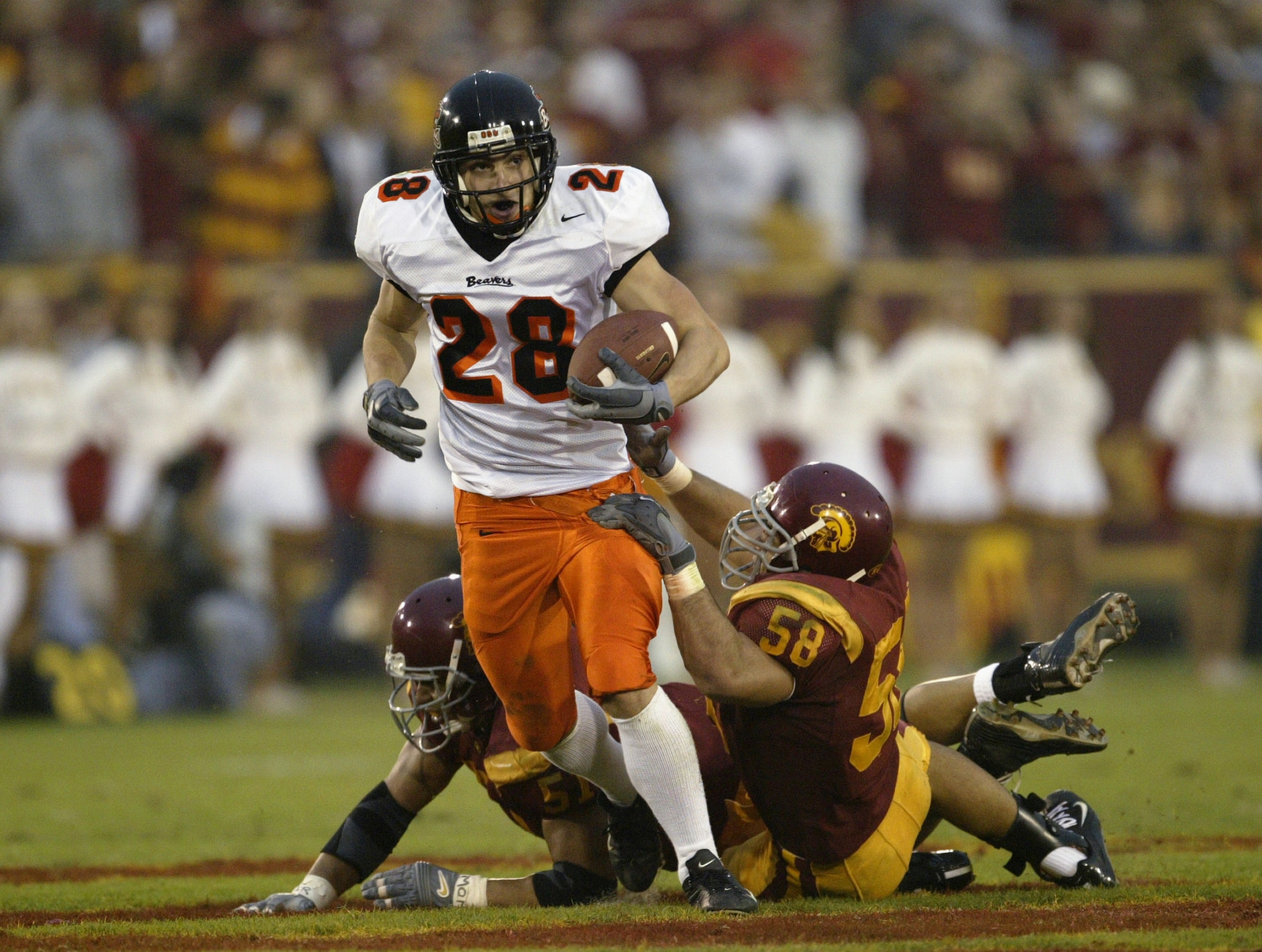 LOS ANGELES - DECEMBER 6:  Wide receiver Mike Hass #28 of the Oregon State Beavers runs after a catch during the game against the USC Trojans on December 6, 2003 at the Los Angeles Coliseum in Los Angeles, California.  USC won 52-28 to become the No. 1 te