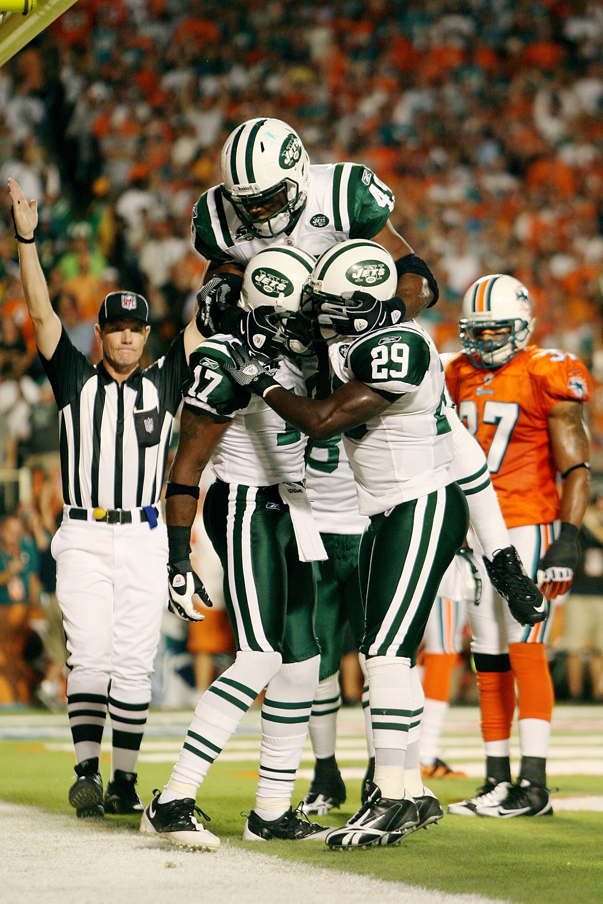MIAMI - OCTOBER 12:  Wide receiver Braylon Edwards #17 of the New York Jets is congratulated by teammates Tony Richardson #49 and Leon Washington #29 after scoring a touchdown in the first quarter against the Miami Dolphins at Land Shark Stadium on Octobe