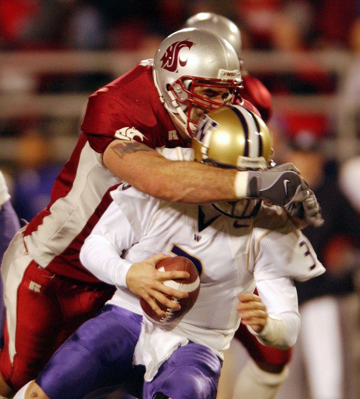 PULLMAN, WA - NOVEMBER 23:  Quarterback Cody Pickett #3 of the Washington Huskies is sacked by Rien Long #88 of the Washington State Cougars on November 23, 2002 at Martin Stadium in Pullman Washington. (Photo by Otto Greule Jr/Getty Images)