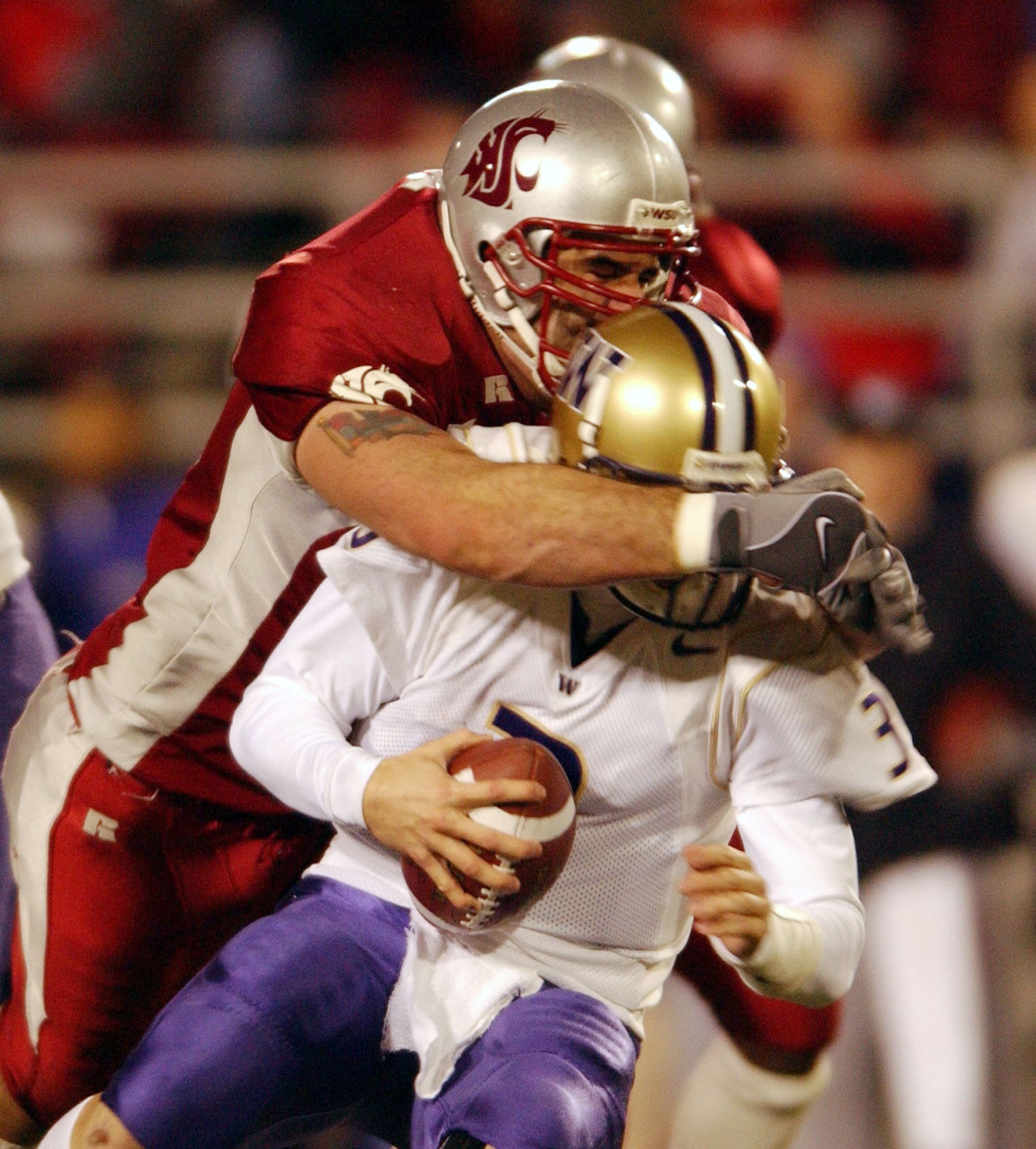 PULLMAN, WA - NOVEMBER 23:  Quarterback Cody Pickett #3 of the Washington Huskies is sacked by Rien Long #88 of the Washington State Cougars on November 23, 2002 at Martin Stadium in Pullman Washington. (Photo by Otto Greule Jr/Getty Images)