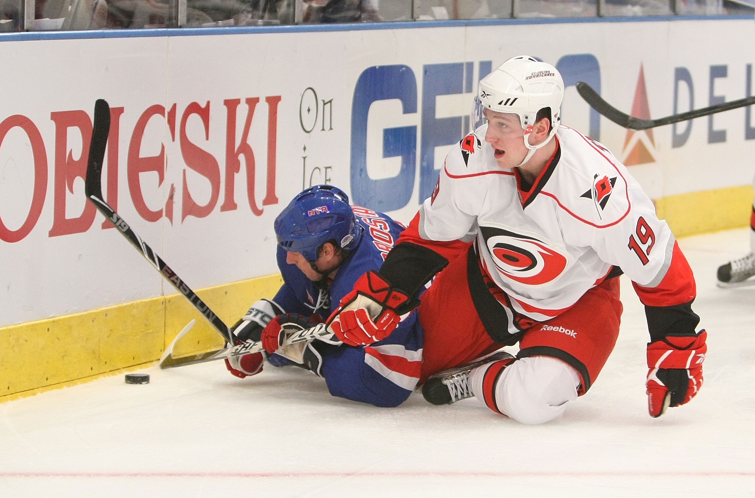 NEW YORK - JANUARY 27: Vinny Prospal #20 of the New York Rangers and Jiri Tlusty #19 of the Carolina Hurricanes fall to the ice at Madison Square Garden on January 27, 2010 in New York, New York.  (Photo by Nick Laham/Getty Images)