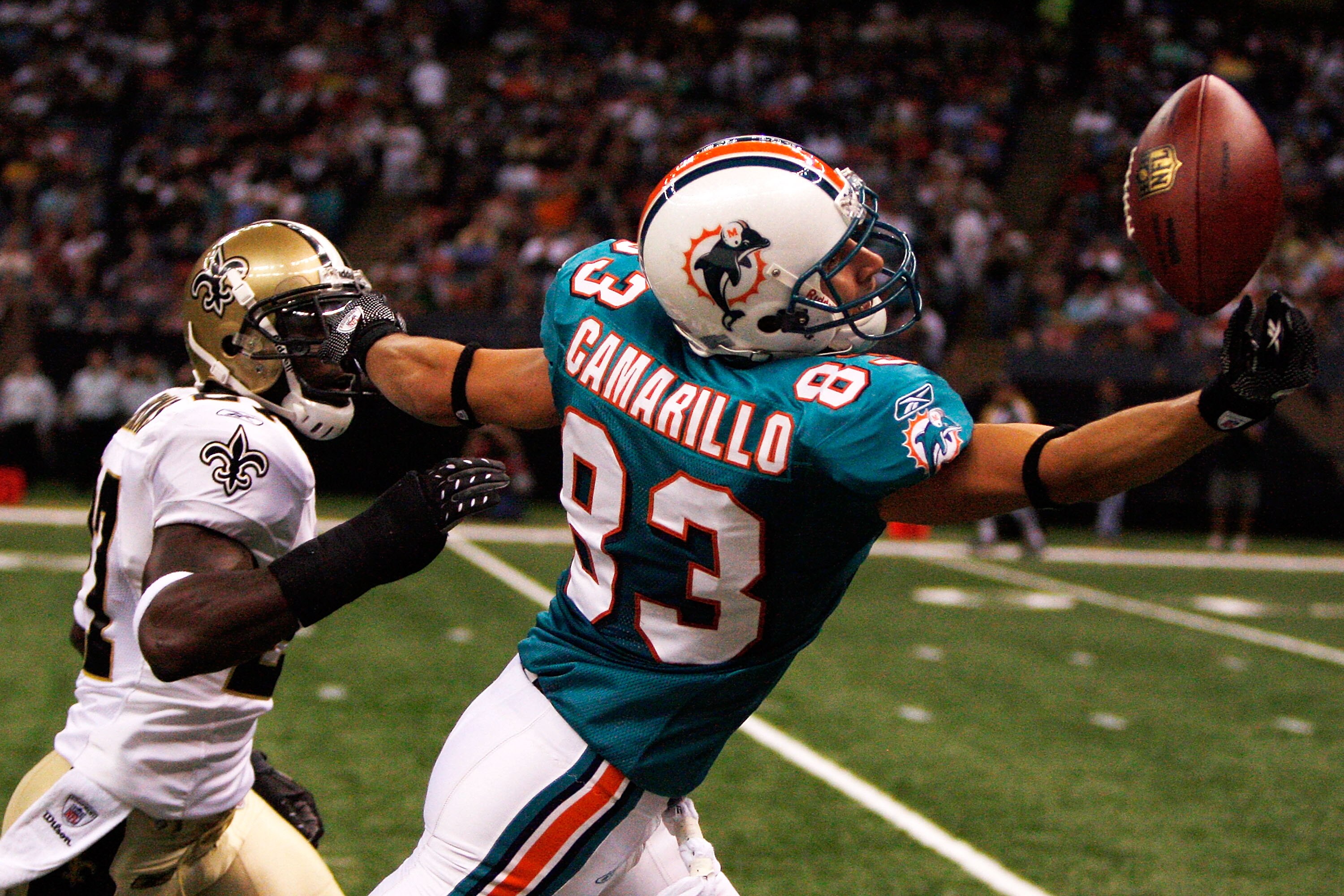 NEW ORLEANS - SEPTEMBER 03:  Greg Camarillo #83 of the Miami Dolphins tries to catch a pass over Malcolm Jenkins #27 of the New Orleans Saints at the Louisiana Superdome on September 3, 2009 in New Orleans, Louisiana.  (Photo by Chris Graythen/Getty Image