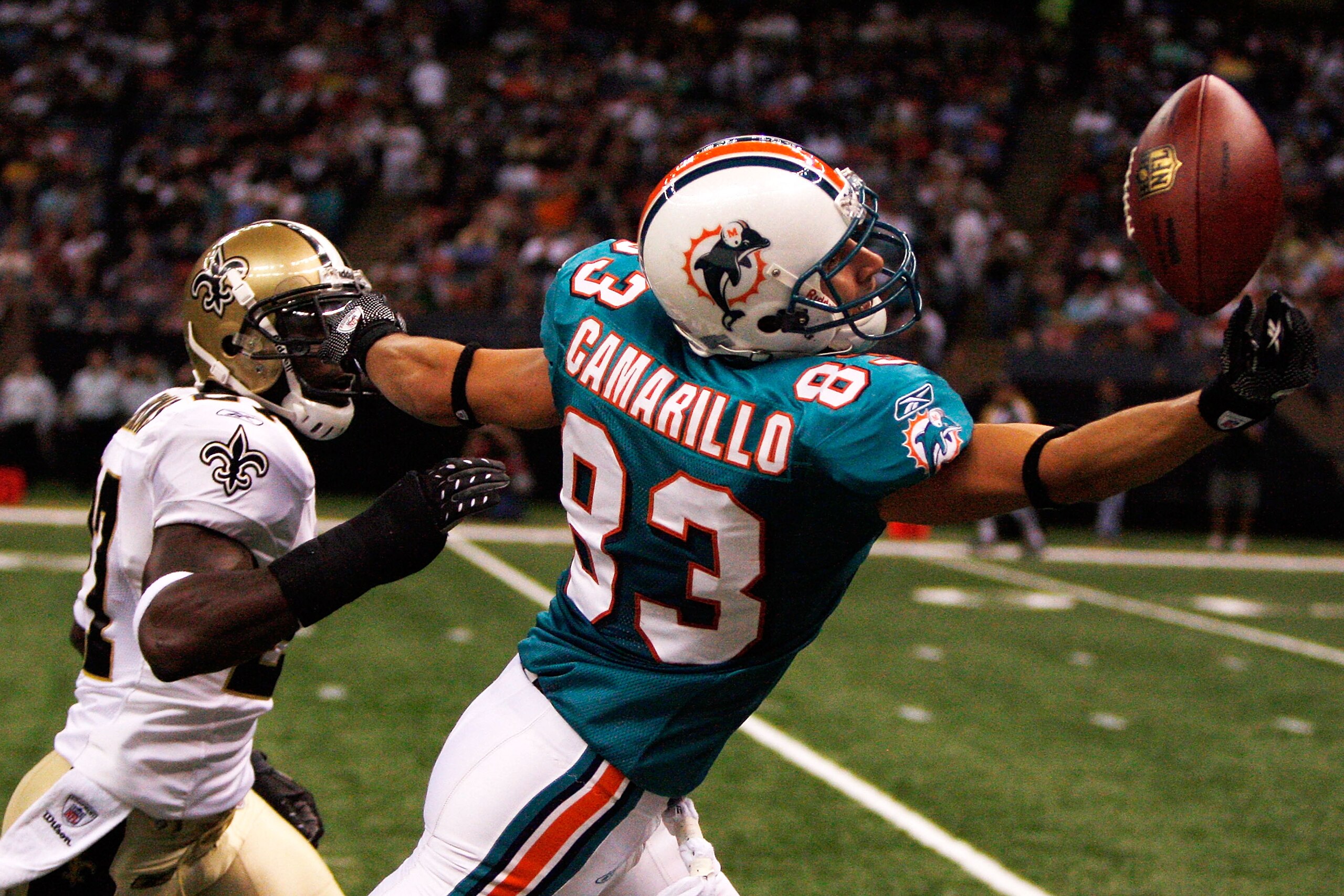 NEW ORLEANS - SEPTEMBER 03:  Greg Camarillo #83 of the Miami Dolphins tries to catch a pass over Malcolm Jenkins #27 of the New Orleans Saints at the Louisiana Superdome on September 3, 2009 in New Orleans, Louisiana.  (Photo by Chris Graythen/Getty Image