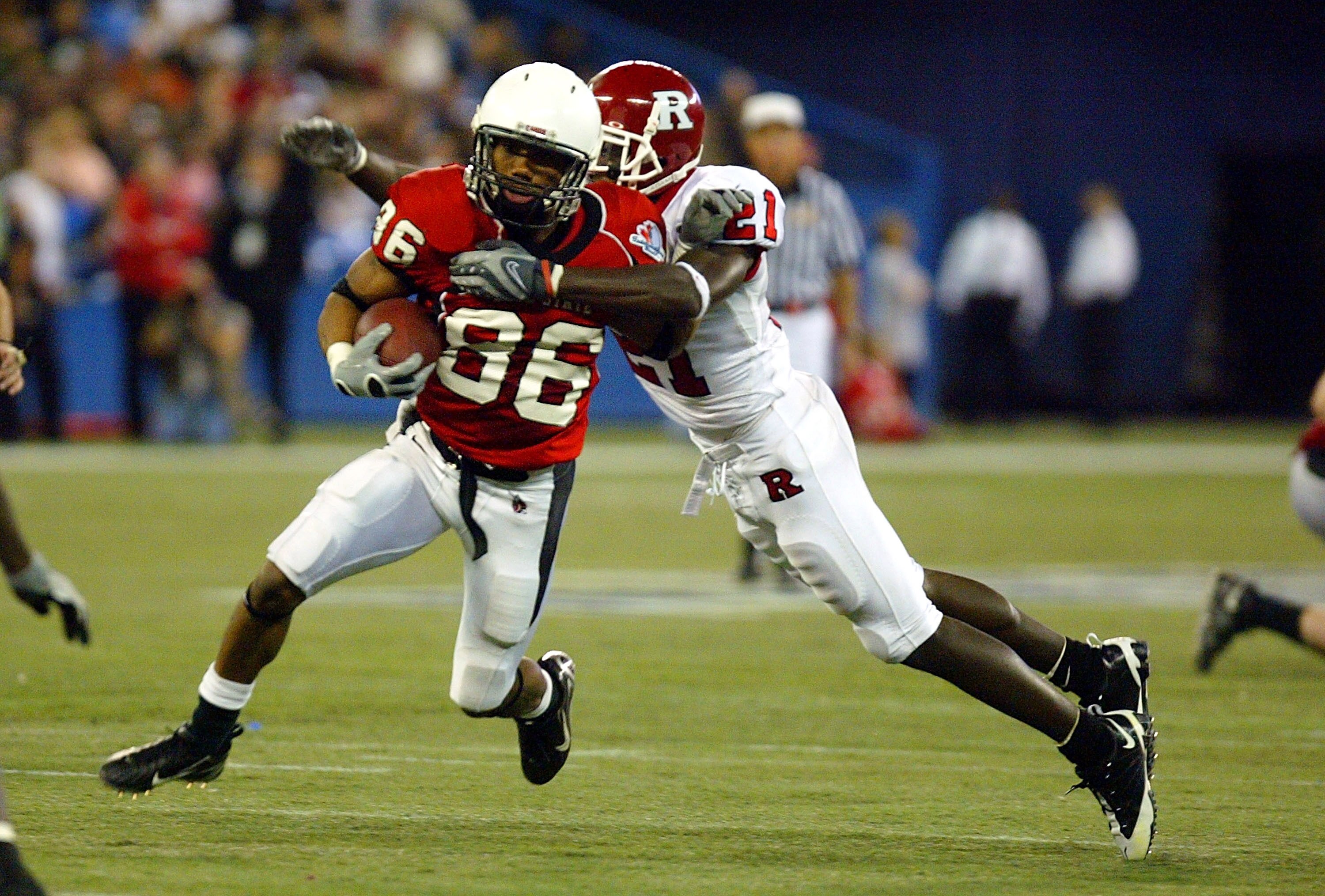 TORONTO - JANUARY 5:  Devin McCourty #21 of the Rutgers Scarlet Knights tackles Dante Love #86 of the Ball State Cardinals during the International Bowl at the Rogers Centre on January 5, 2008 in Toronto, Ontario, Canada.  (Photo by Dave Sandford/Getty Im