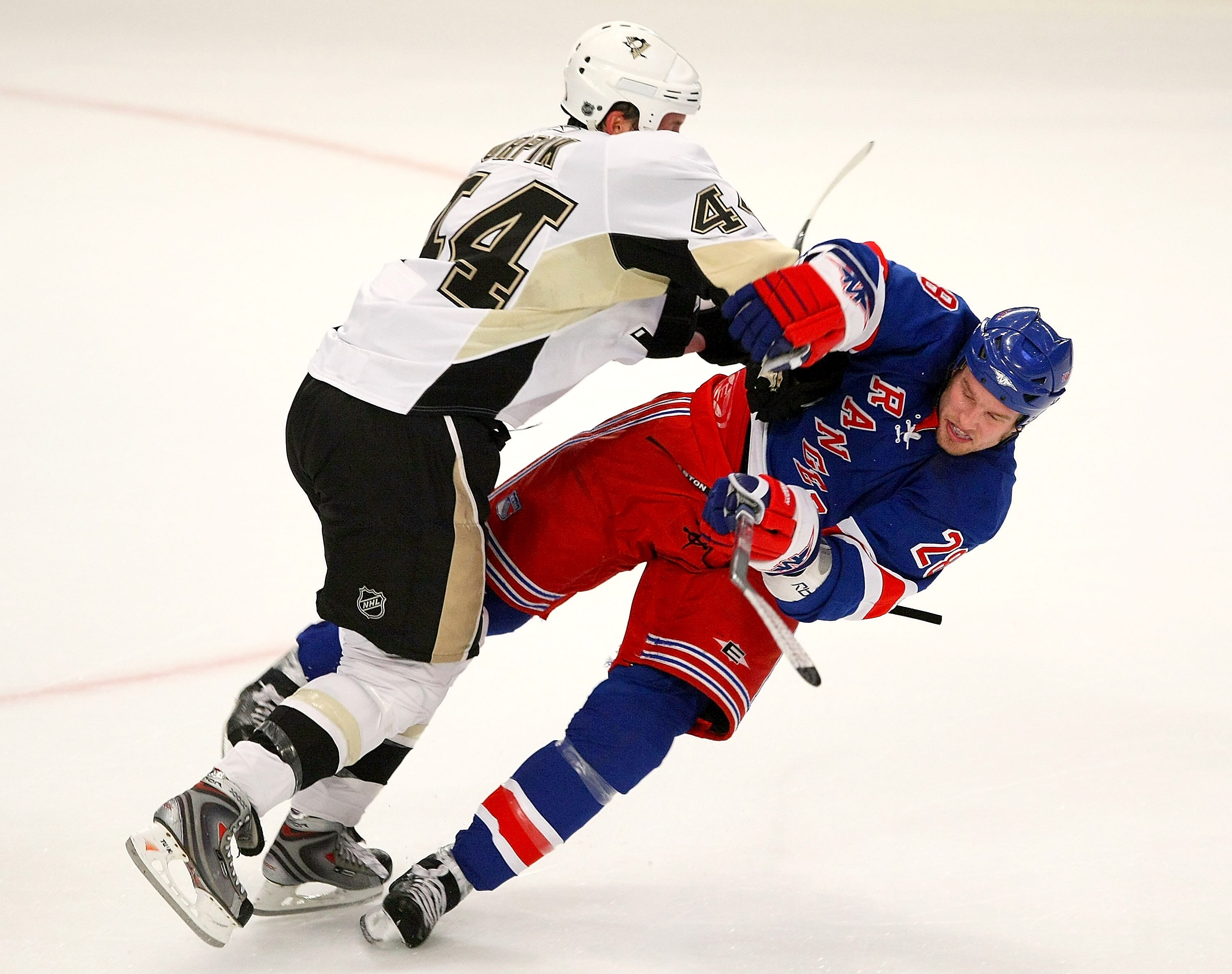 NEW YORK - OCTOBER 25: Brooks Orpik #44 of the Pittsburgh Penguins hits Colton Orr #28 of the New York Rangers on October 25, 2008 at Madison Square Garden in New York City. (Photo by Bruce Bennett/Getty Images)