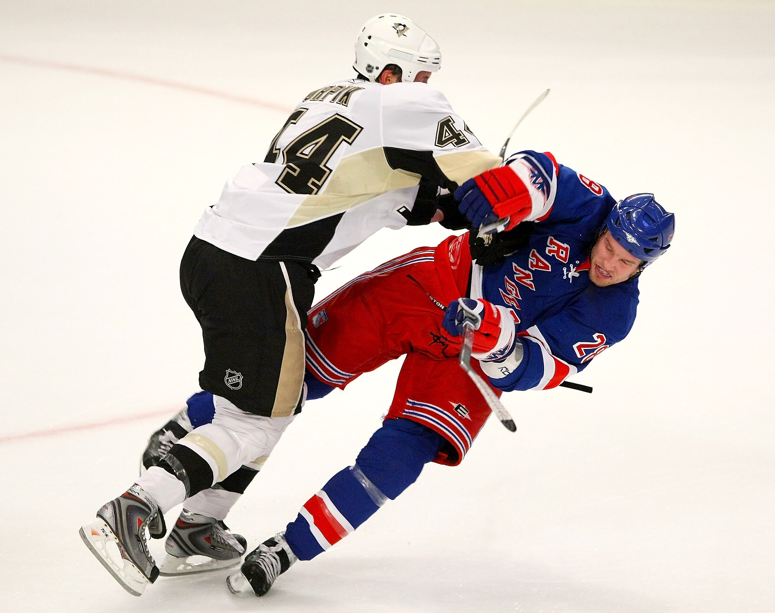 NEW YORK - OCTOBER 25: Brooks Orpik #44 of the Pittsburgh Penguins hits Colton Orr #28 of the New York Rangers on October 25, 2008 at Madison Square Garden in New York City. (Photo by Bruce Bennett/Getty Images)