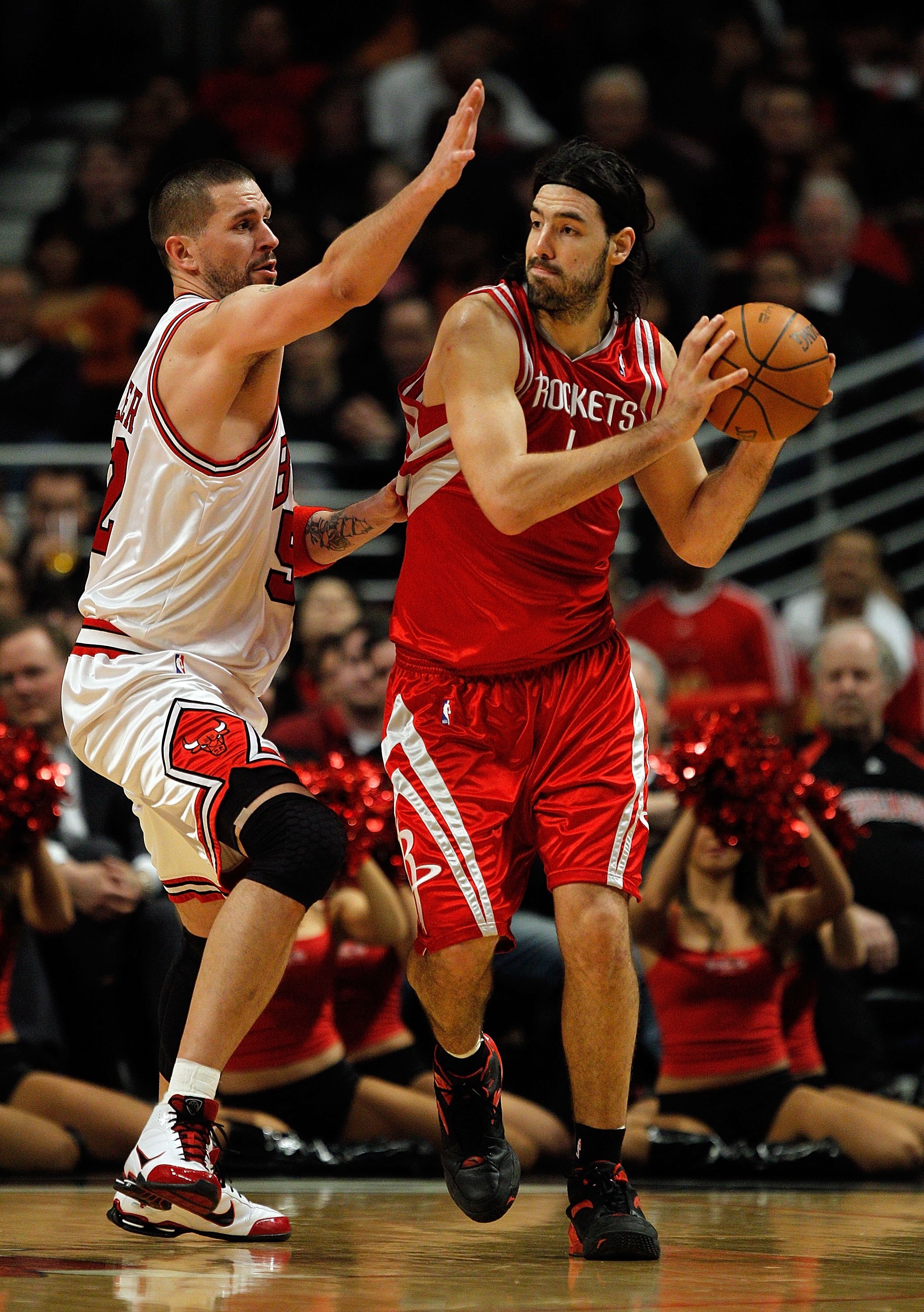 CHICAGO - MARCH 22: Luis Scola #4 of the Houston Rockets looks to pass under pressure from Brad Miller #52 of the Chicago Bulls at the United Center on March 22, 2010 in Chicago, Illinois. The Bulls defeated the Rockets 98-88. NOTE TO USER: User expressly